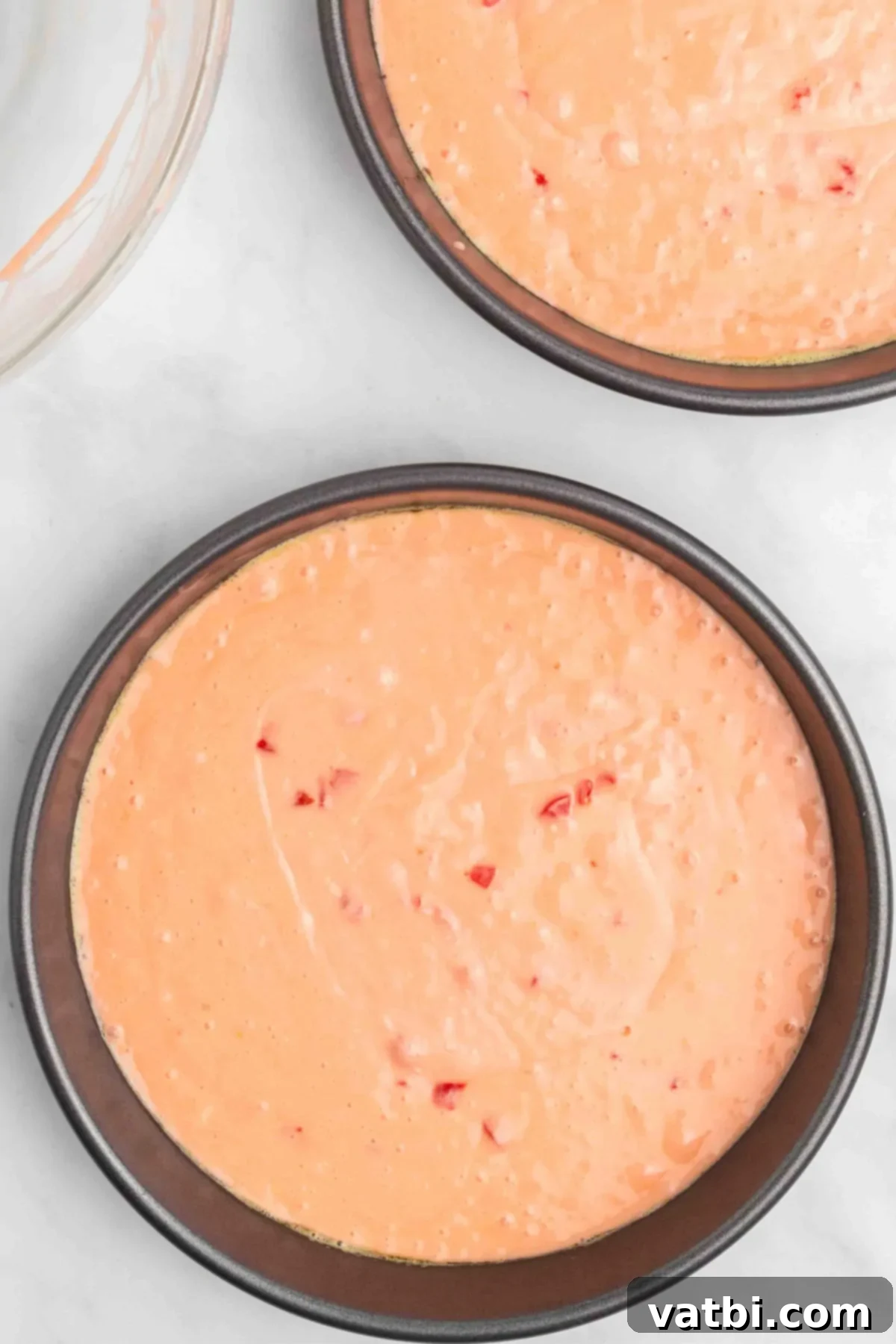Perfect Cherry Chip Cake 8 Pink cake batter poured evenly into two round cake pans.
