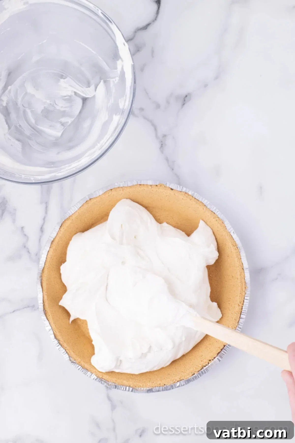 Effortless Philadelphia No-Bake Cheesecake 6 A graham cracker pie crust filled with the light and airy no-bake cheesecake mixture, smoothed evenly with a rubber spatula.