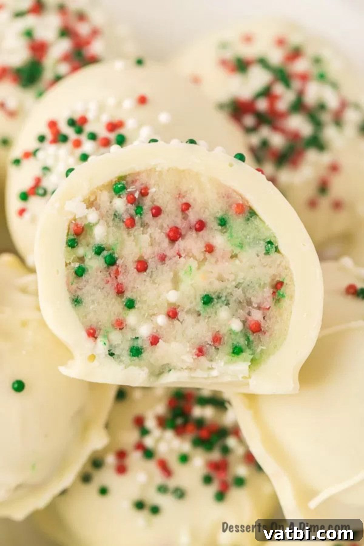 Holiday Truffle Magic 2 Festive Christmas Truffles coated in white chocolate and topped with red and green sprinkles, arranged beautifully for a holiday treat.