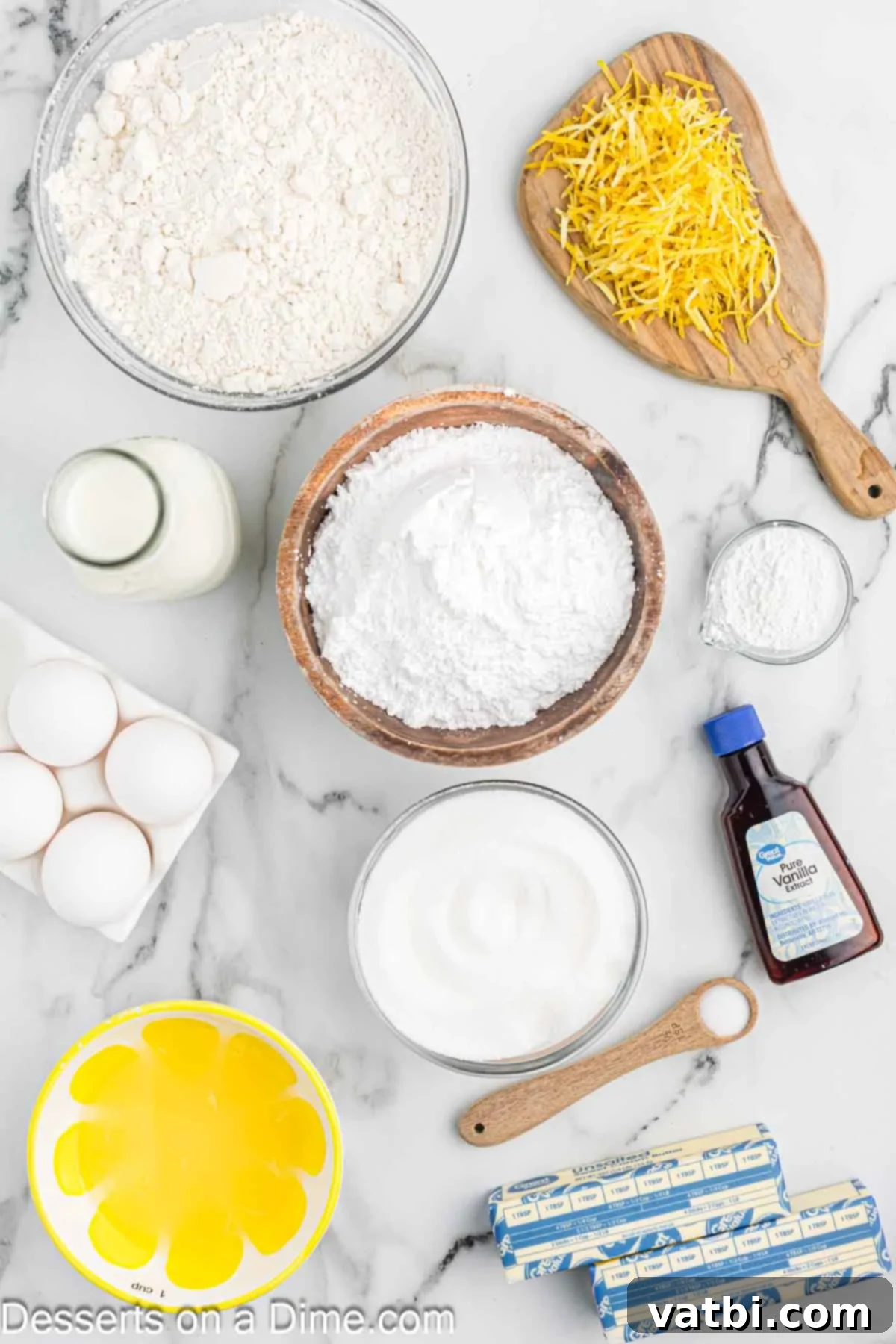 Sun-Kissed Lemon Cake Delight 3 Ingredients for recipe- flour, baking soda. butter, sugar, lemon, vanilla, whole milk, powdered sugar, vanilla. A selection of fresh ingredients laid out for baking lemon cake: flour, butter, sugar, lemons, milk, and extracts.