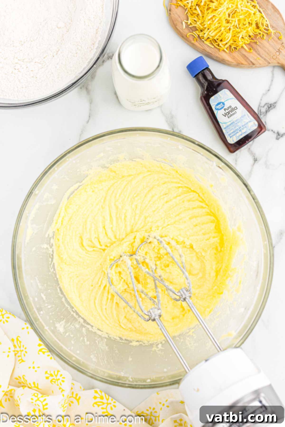 Sun-Kissed Lemon Cake Delight 5 Mixing bowl with butter and sugar being creamed. Room temperature butter and granulated sugar beaten until fluffy.