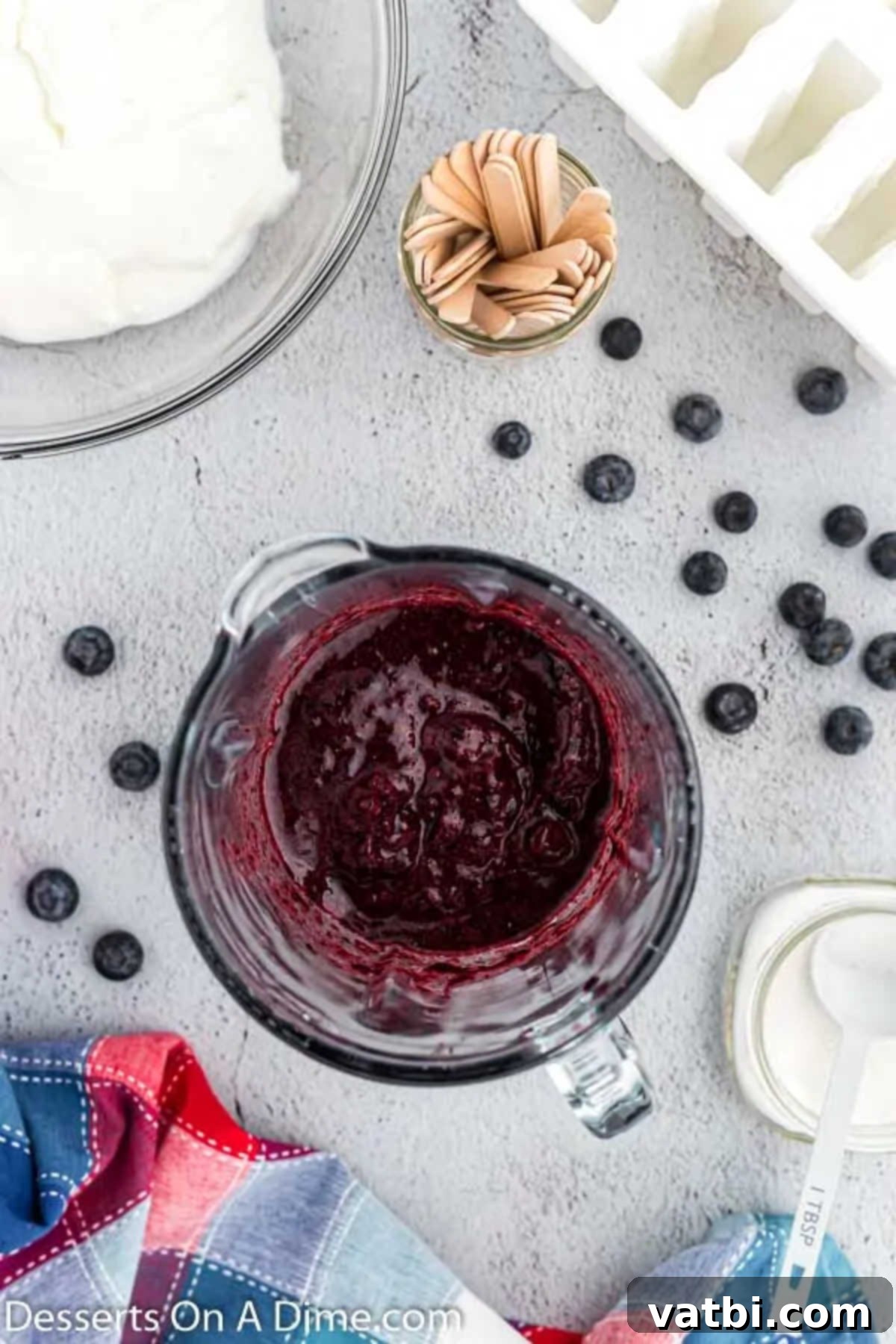 Blueberry Freeze Pops 4 Fresh blueberries and granulated sugar ready to be blended in a food processor, showing the initial ingredients.