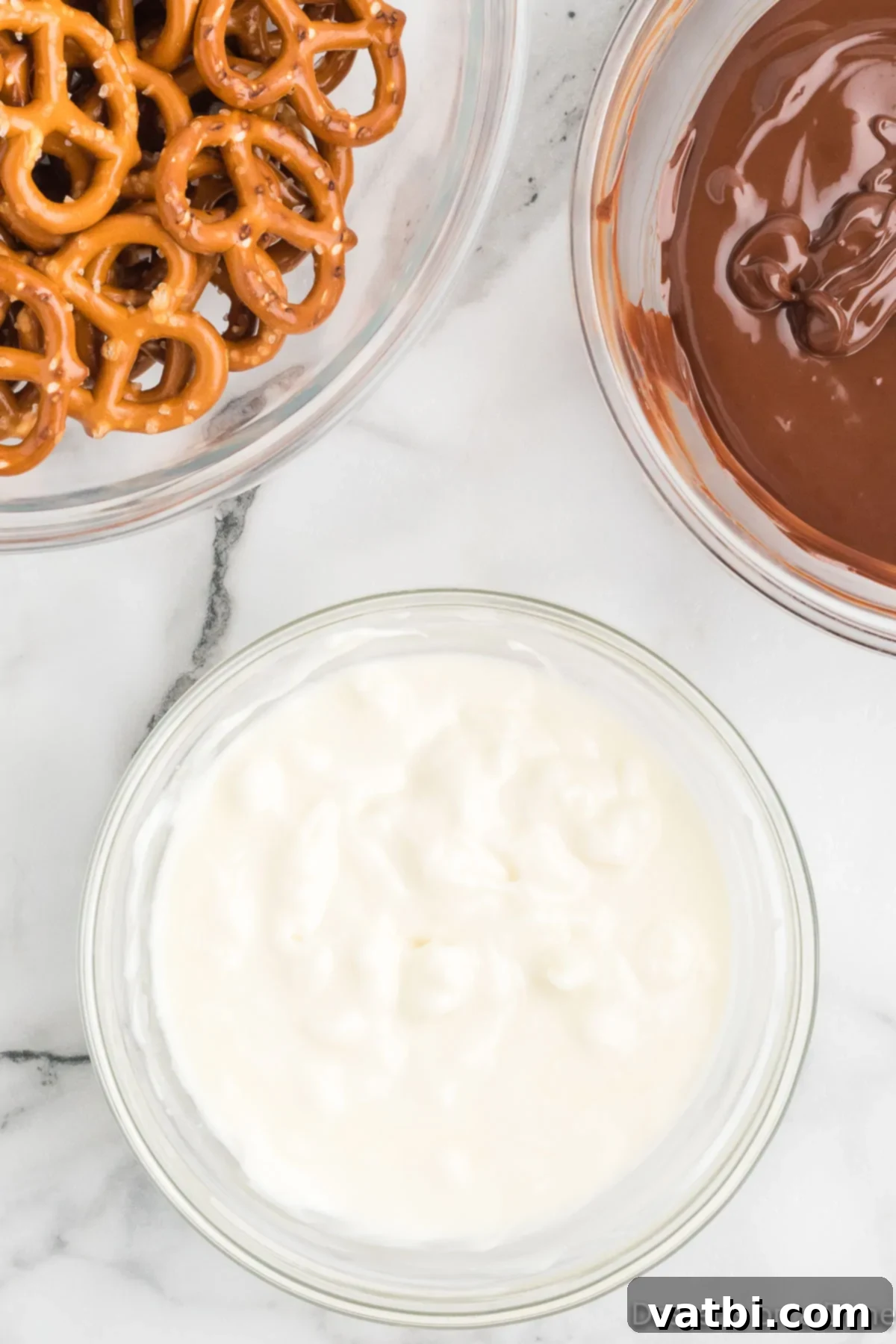 Sweet & Salty Pretzel Bliss 5 A separate bowl containing smoothly melted white chocolate, ready for dipping pretzels.