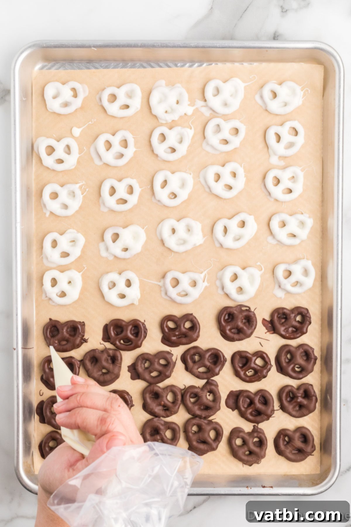 Sweet & Salty Pretzel Bliss 10 Milk chocolate-covered pretzels with contrasting white chocolate drizzles, creating an elegant striped pattern.