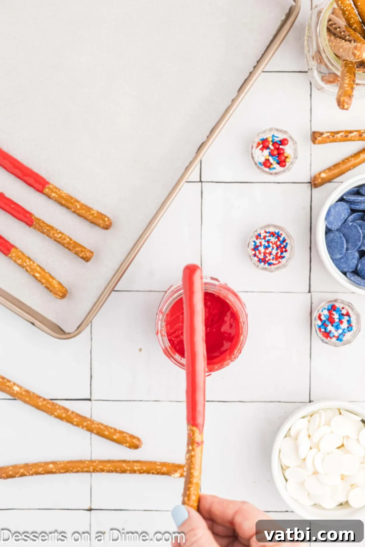 Red, White, and Sweet Pretzel Rods 2 Red, white, and blue candy melts prepared in separate tall glasses, ready for dipping.