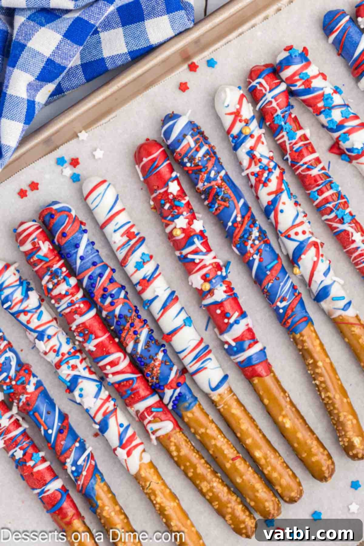 Red, White, and Sweet Pretzel Rods 5 Finished 4th of July chocolate covered pretzel rods standing upright in a mason jar, ready to be served.
