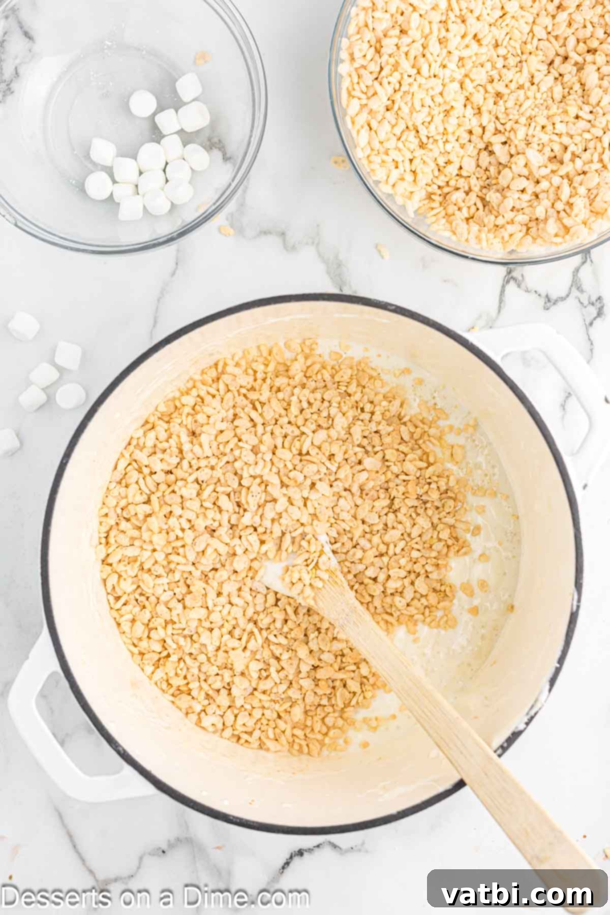 The Ultimate Rice Krispie Treat Recipe 7 Rice Krispie cereal being poured into the melted marshmallow mixture.