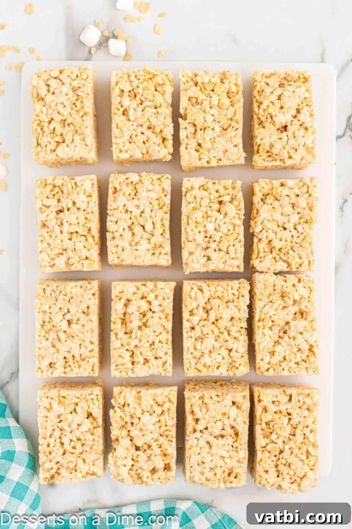 The Ultimate Rice Krispie Treat Recipe 10 Cooled Rice Krispie Treats cut into squares in the baking pan.