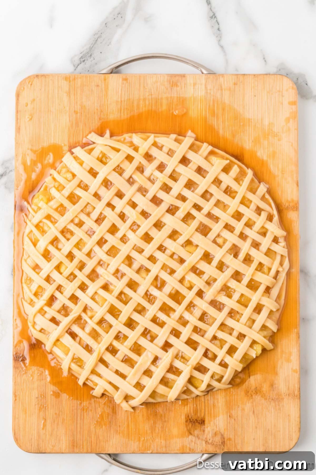 Apple Pie Stuffed Cookies 6 Lattice pie crust strips placed over the apple filling on the pie crust base.