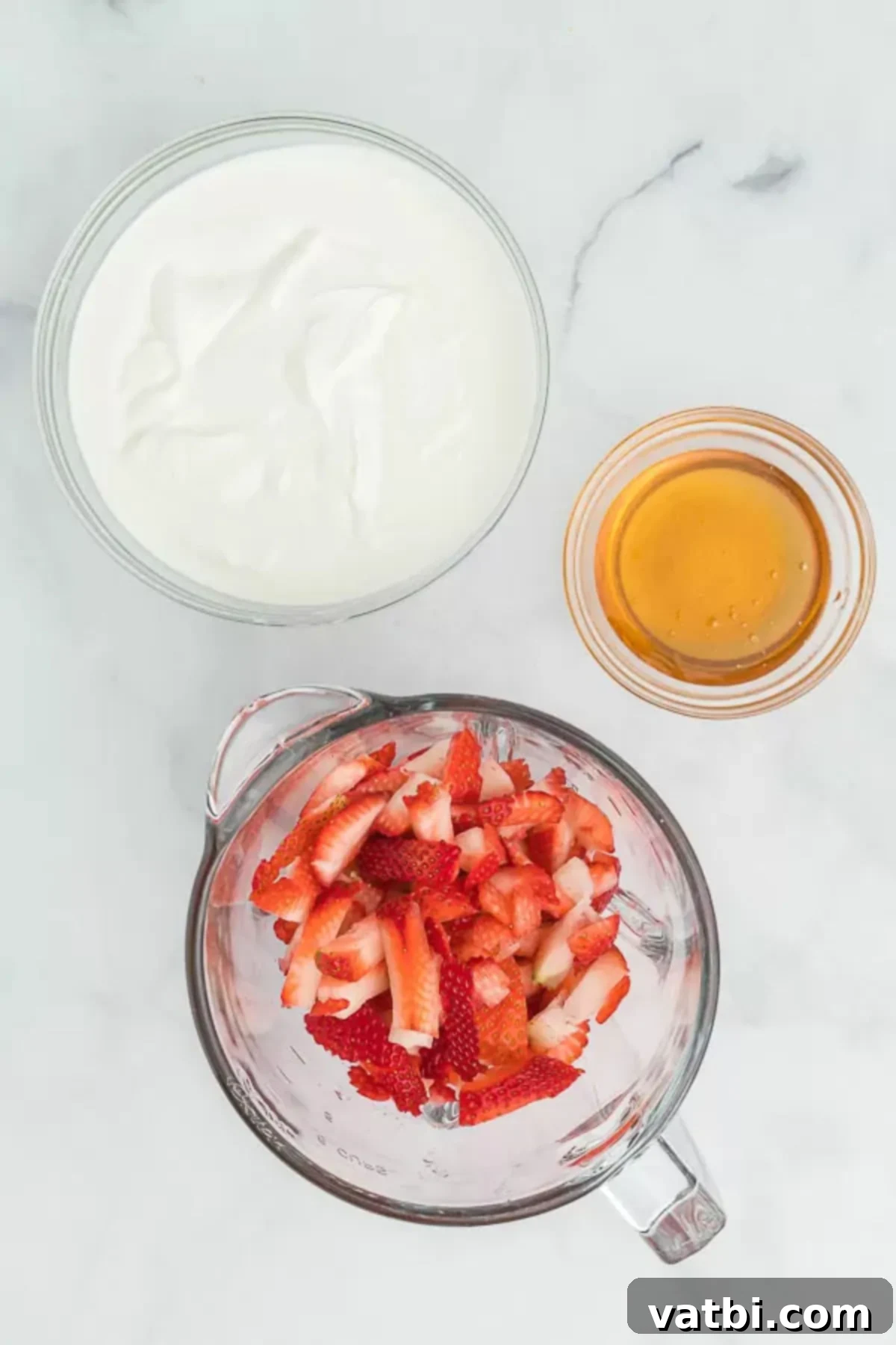Refreshing Strawberry Yogurt Pops 3 Ingredients for Strawberry yogurt popsicles - Greek Yogurt, strawberries, honey. Fresh, wholesome ingredients ready to be blended.
