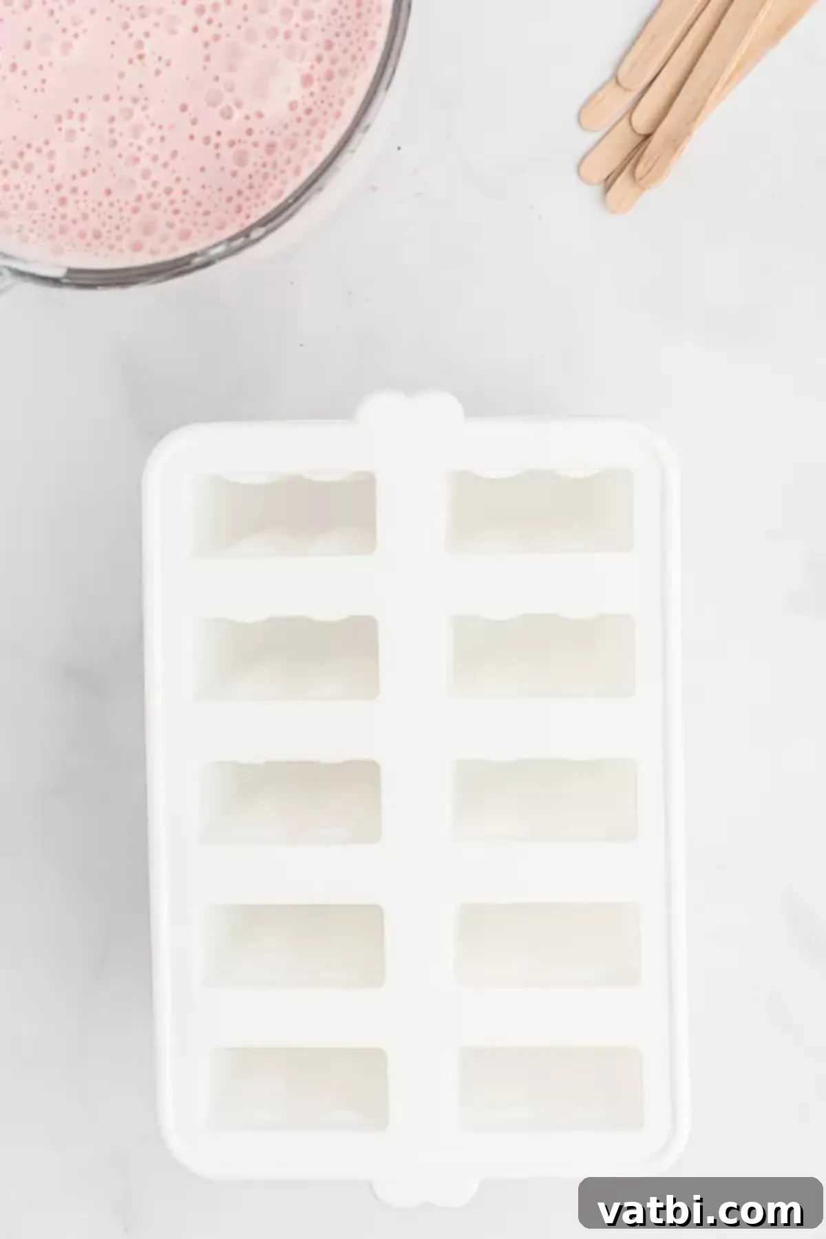 Refreshing Strawberry Yogurt Pops 4 Popsicle mold on the counter. A clean, empty popsicle mold, ready for the delicious mixture.
