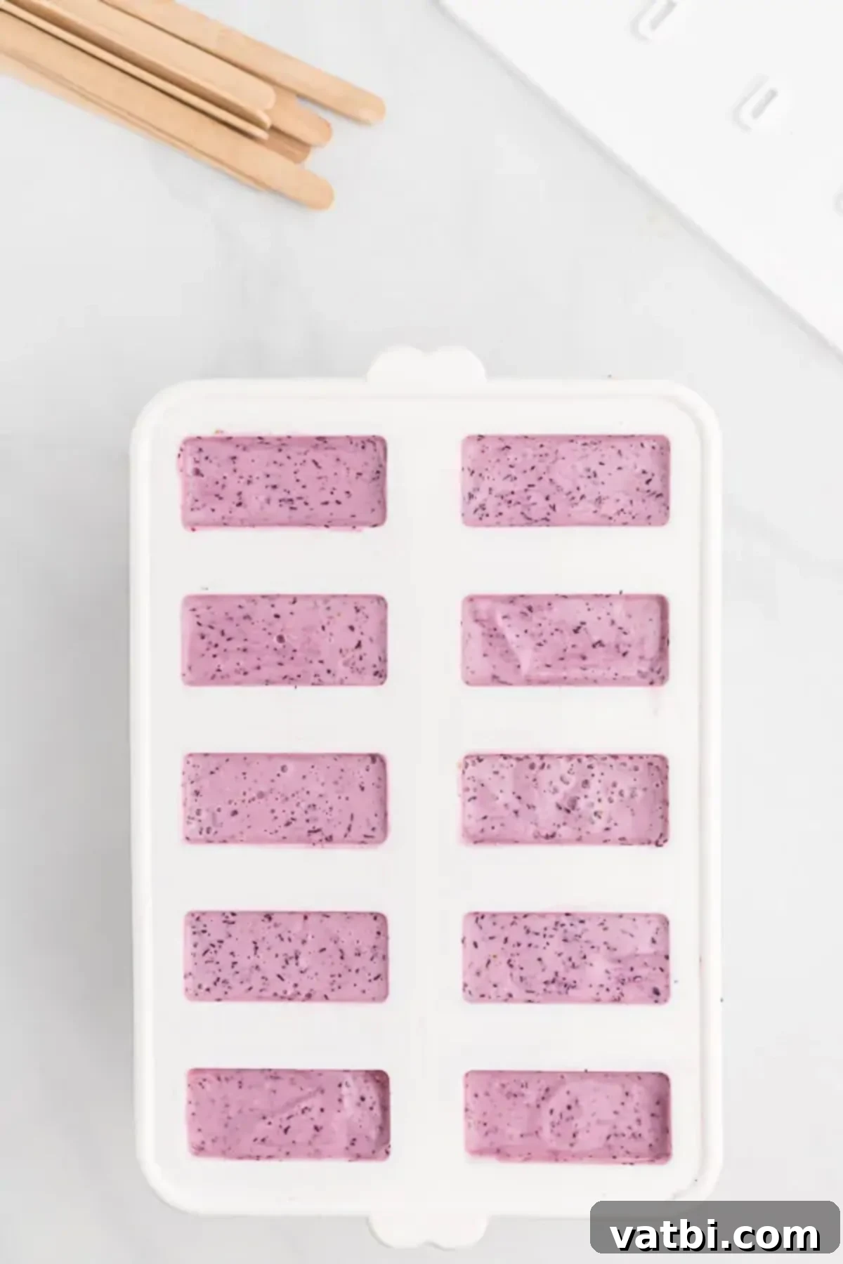 Berry Bliss Yogurt Pops 5 Popsicle mixture being poured into molds