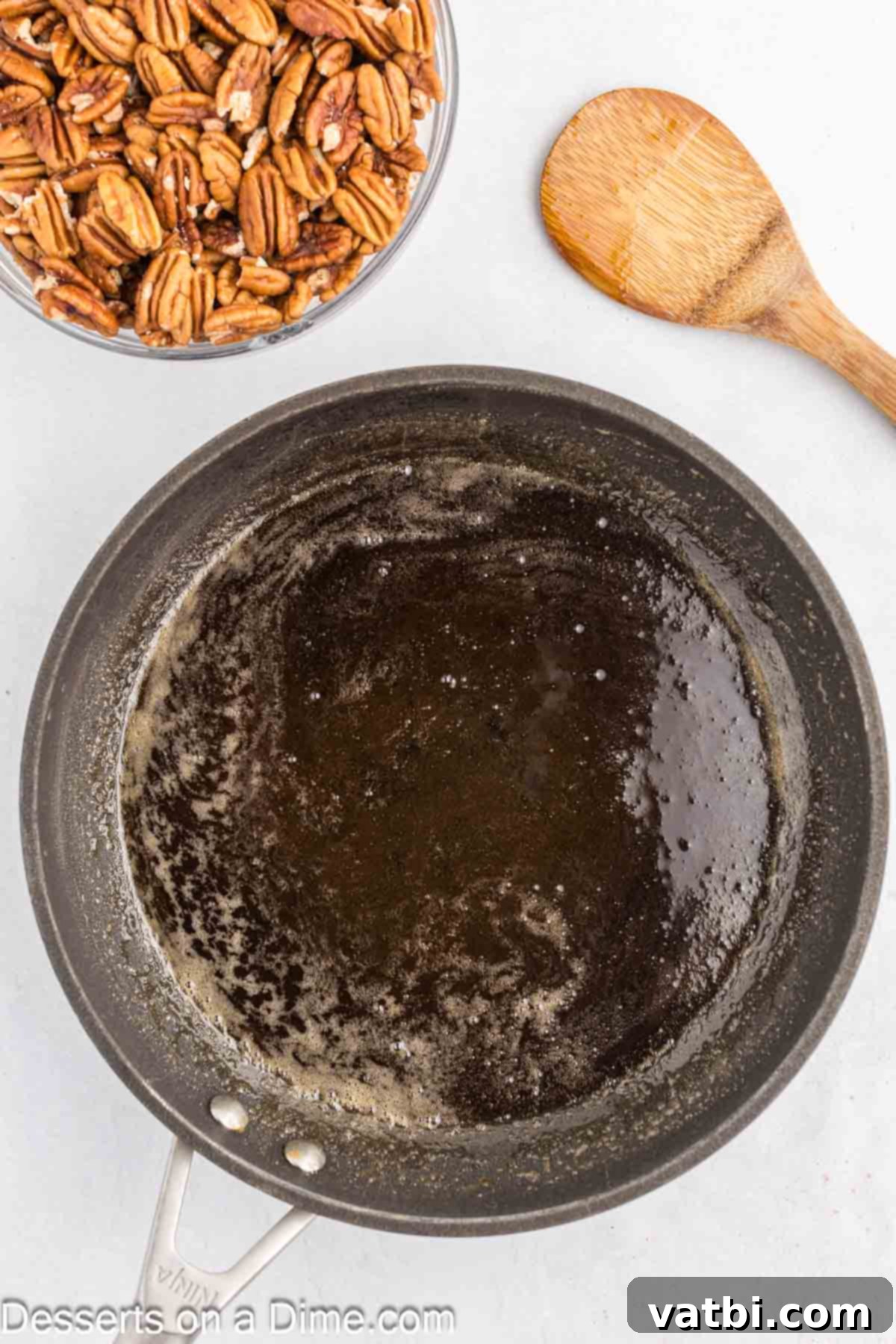 Melted butter, brown sugar, and water simmering in a non-stick skillet.