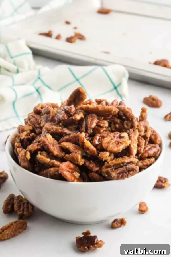 A bowl of finished, crunchy candied pecans ready for serving.