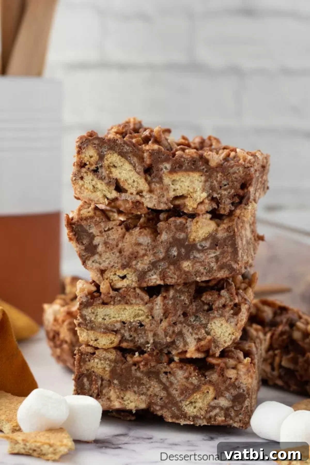 Campfire S'mores Rice Krispie Treats 7 Stacked, perfectly cut S'mores Rice Krispie bars on a cutting board, ready for serving.