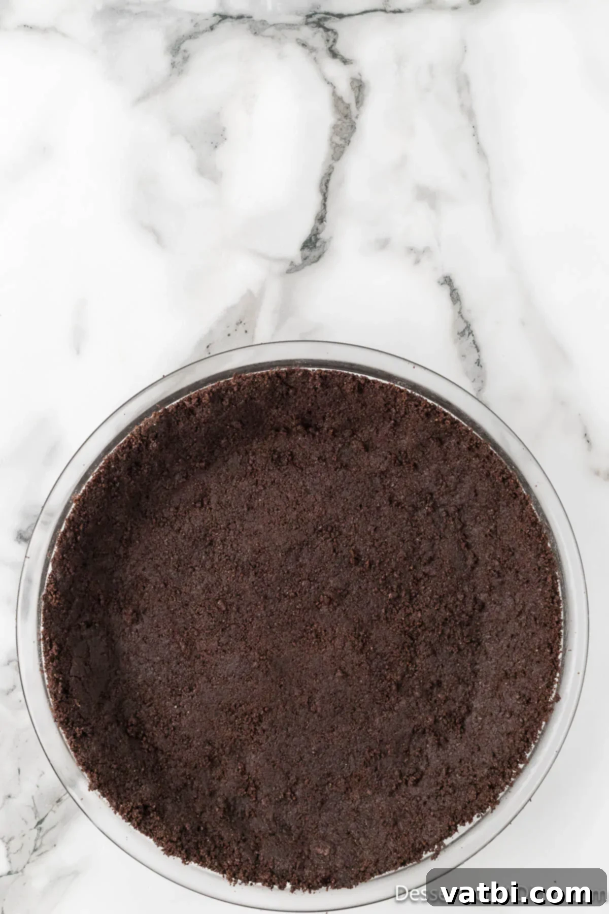 Effortless Oreo Indulgence 5 Oreo crust mixture pressed firmly into a 9-inch pie plate.
