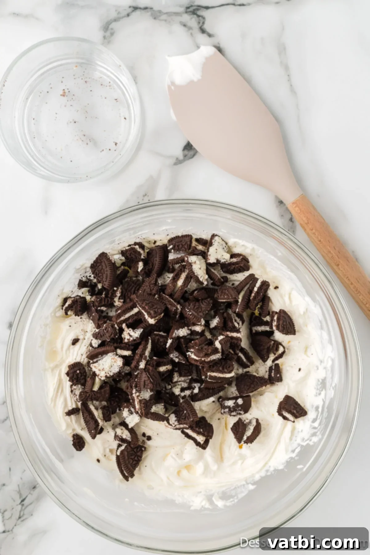 Effortless Oreo Indulgence 7 Whipped topping and chopped Oreo cookies gently folded into the cream cheese mixture.