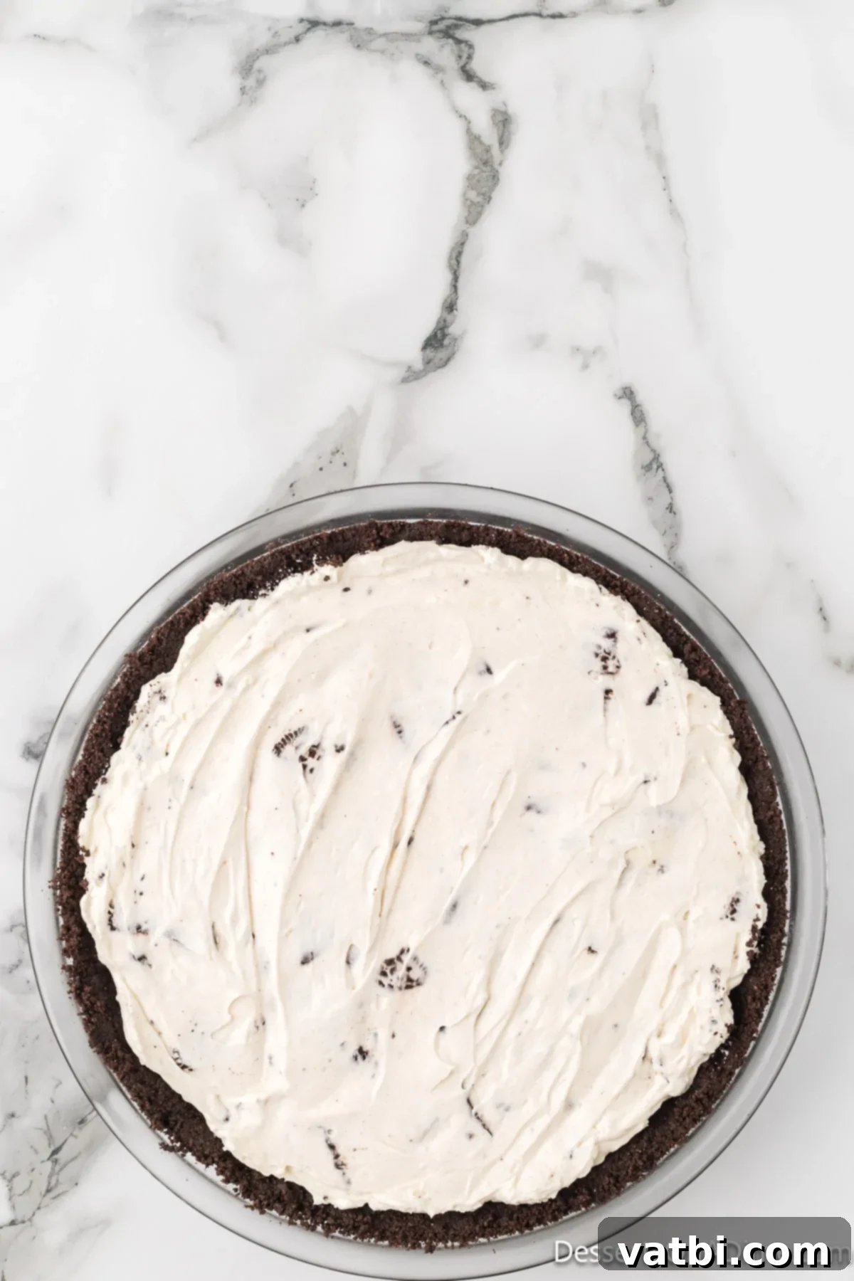 Effortless Oreo Indulgence 9 The assembled No-Bake Oreo Pie with a smooth, even top, ready for chilling.