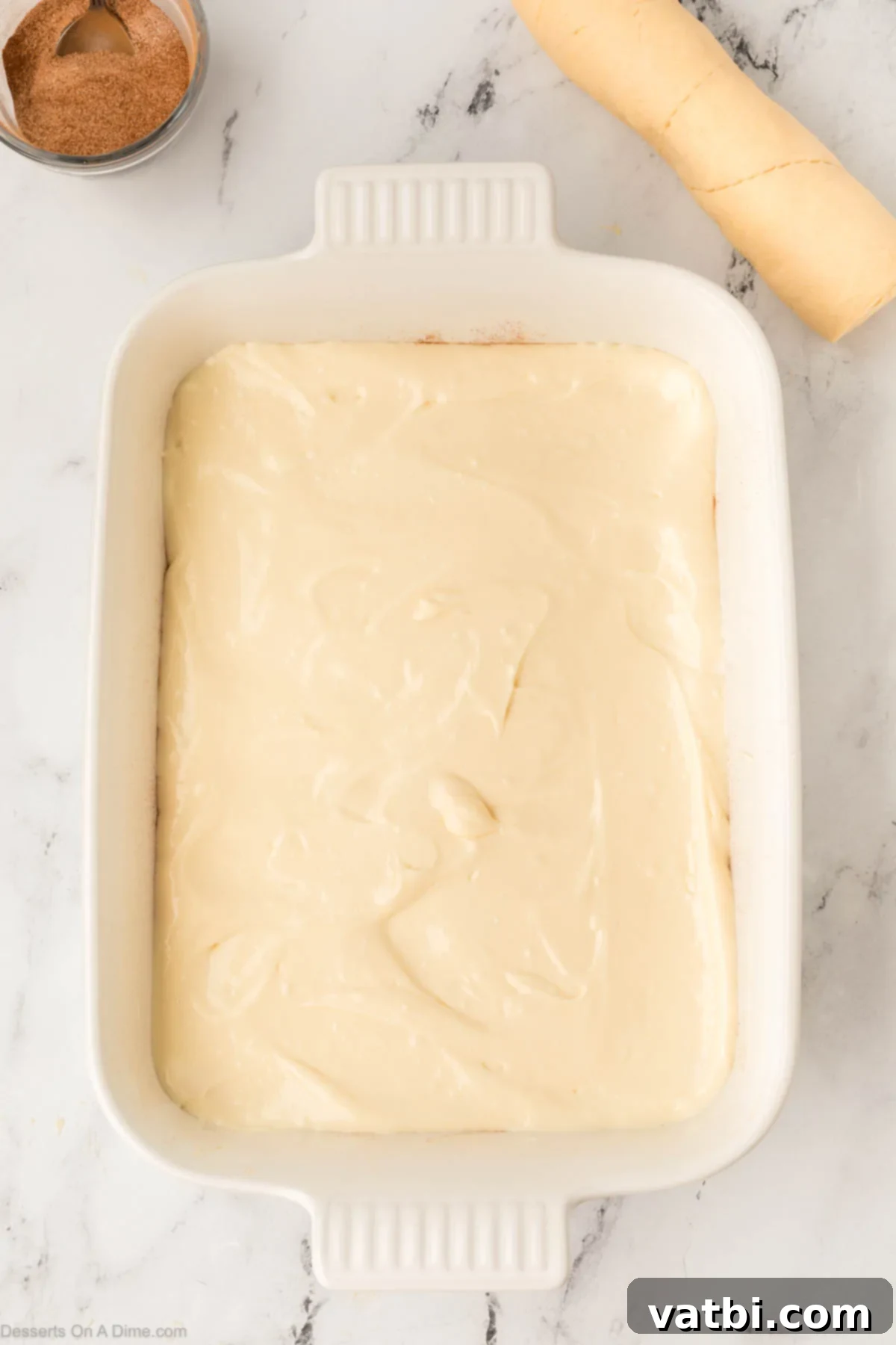 Cinnamon Sugar Cheesecake 10 The creamy cheesecake filling spread evenly over the bottom crescent dough layer in the 9x13 inch baking dish.