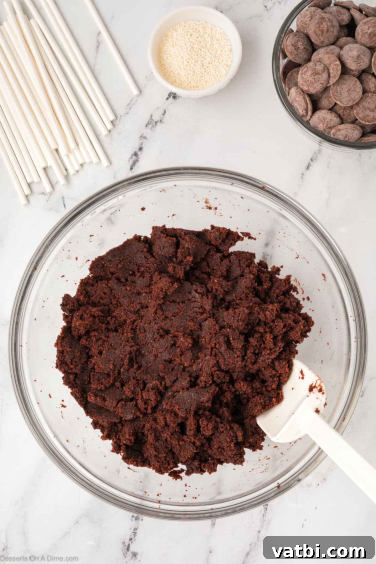 Copycat Starbucks Chocolate Cake Pops 8 Chocolate cake crumbs and chocolate fudge frosting are mixed together in a bowl, creating a rich, dark cake pop base.