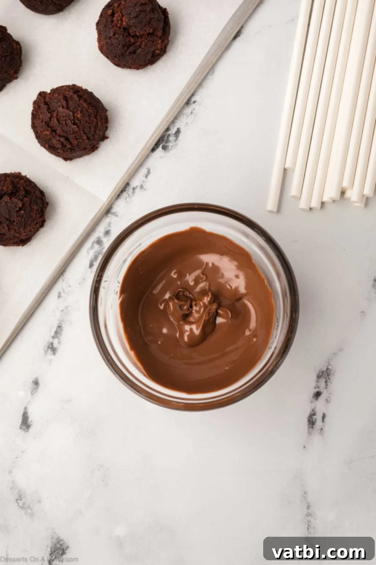 Copycat Starbucks Chocolate Cake Pops 10 Chocolate candy melts are perfectly melted and smooth in a small microwave-safe bowl.