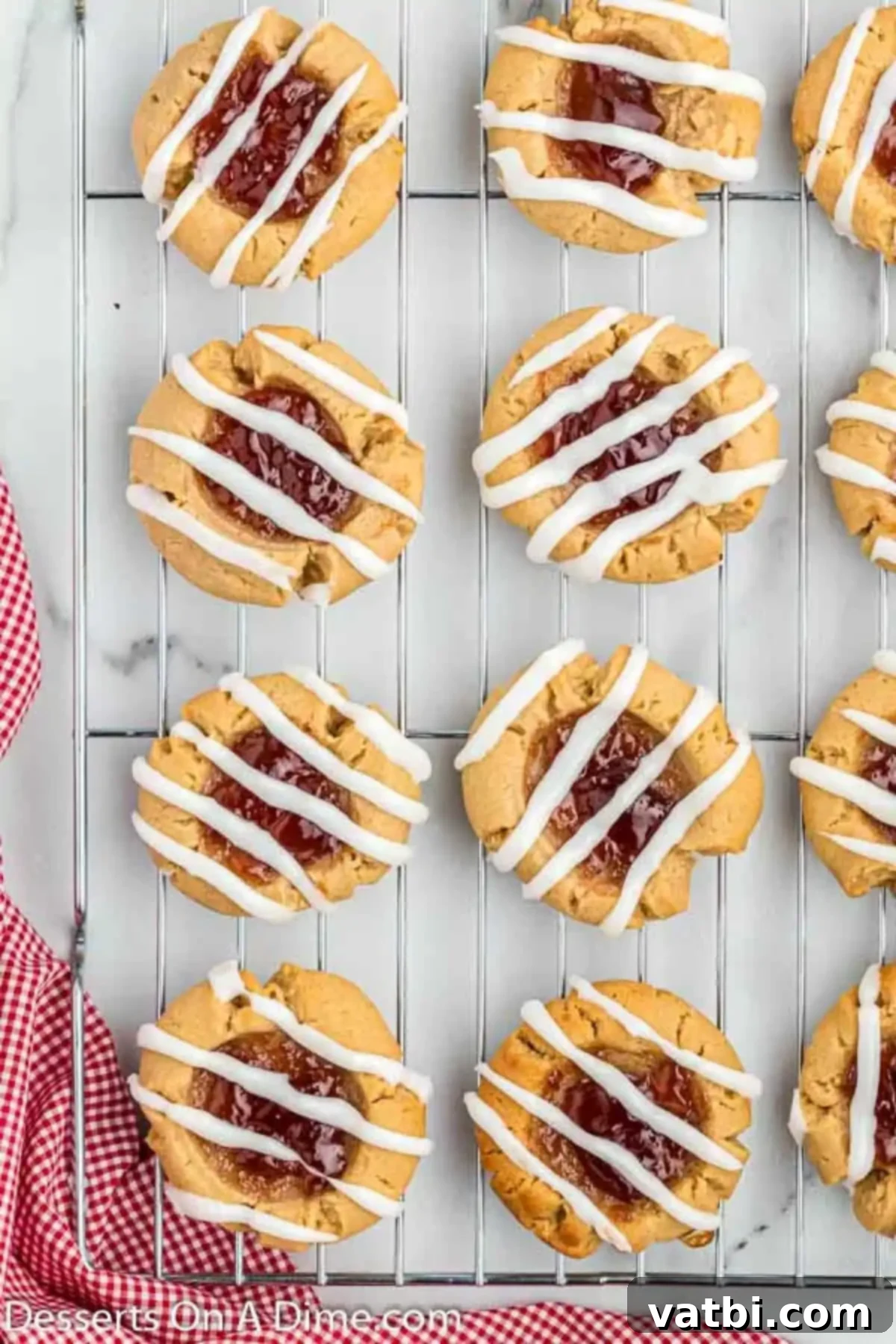 PB&J Cookie Perfection 11 Cookies on a wire rack with glaze drizzled on top, cooling completely.