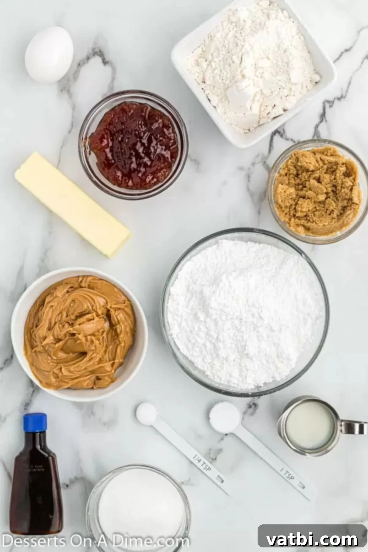 PB&J Cookie Perfection 3 Ingredients for Peanut butter and jelly cookies - butter, creamy peanut butter, flour, baking soda, strawberry jam, powdered sugar, milk, vanilla. These core ingredients come together to create a delightful, nostalgic dessert.