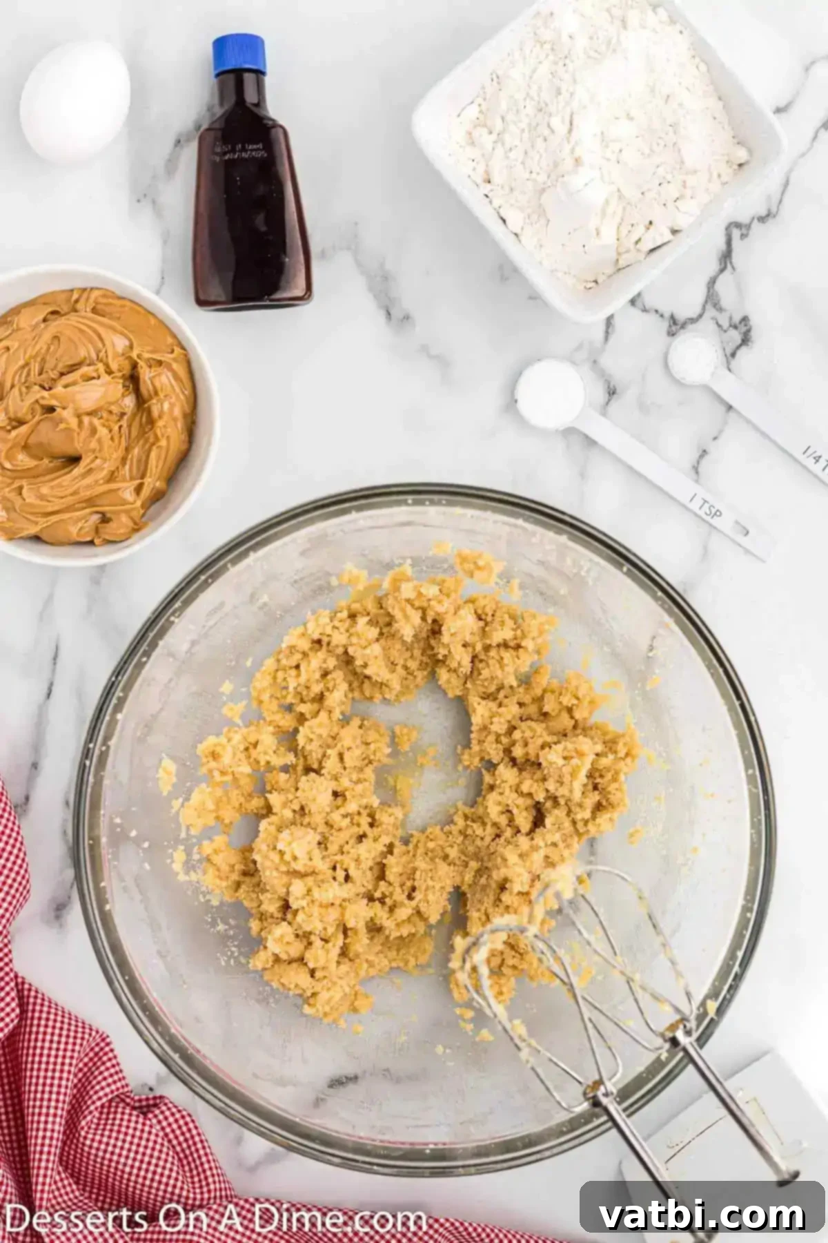 PB&J Cookie Perfection 4 Butter and sugar combined in a bowl for peanut butter and jelly cookies, showing a light and fluffy mixture.