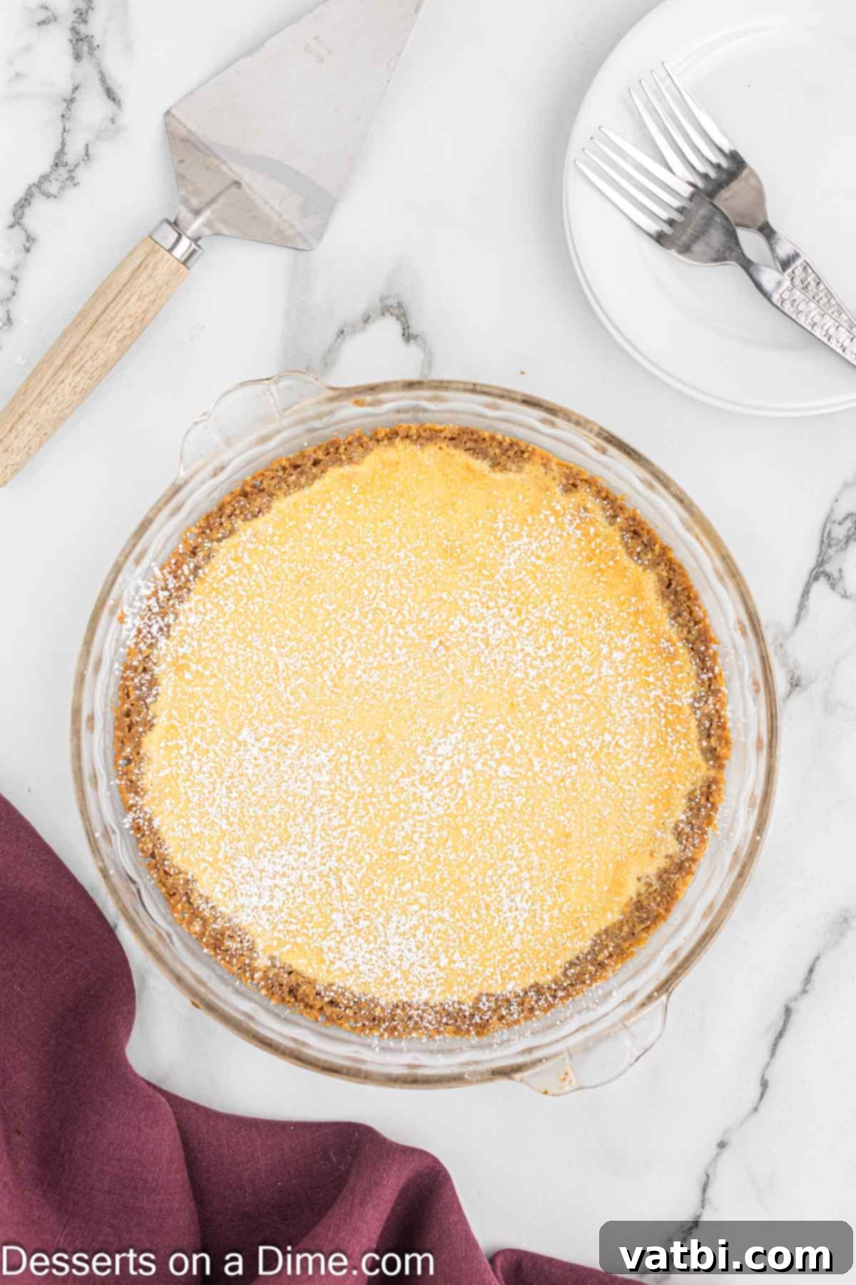 Irresistible Milk Bar Pie 2 Crack Pie in a clear pie pan, perfectly golden brown