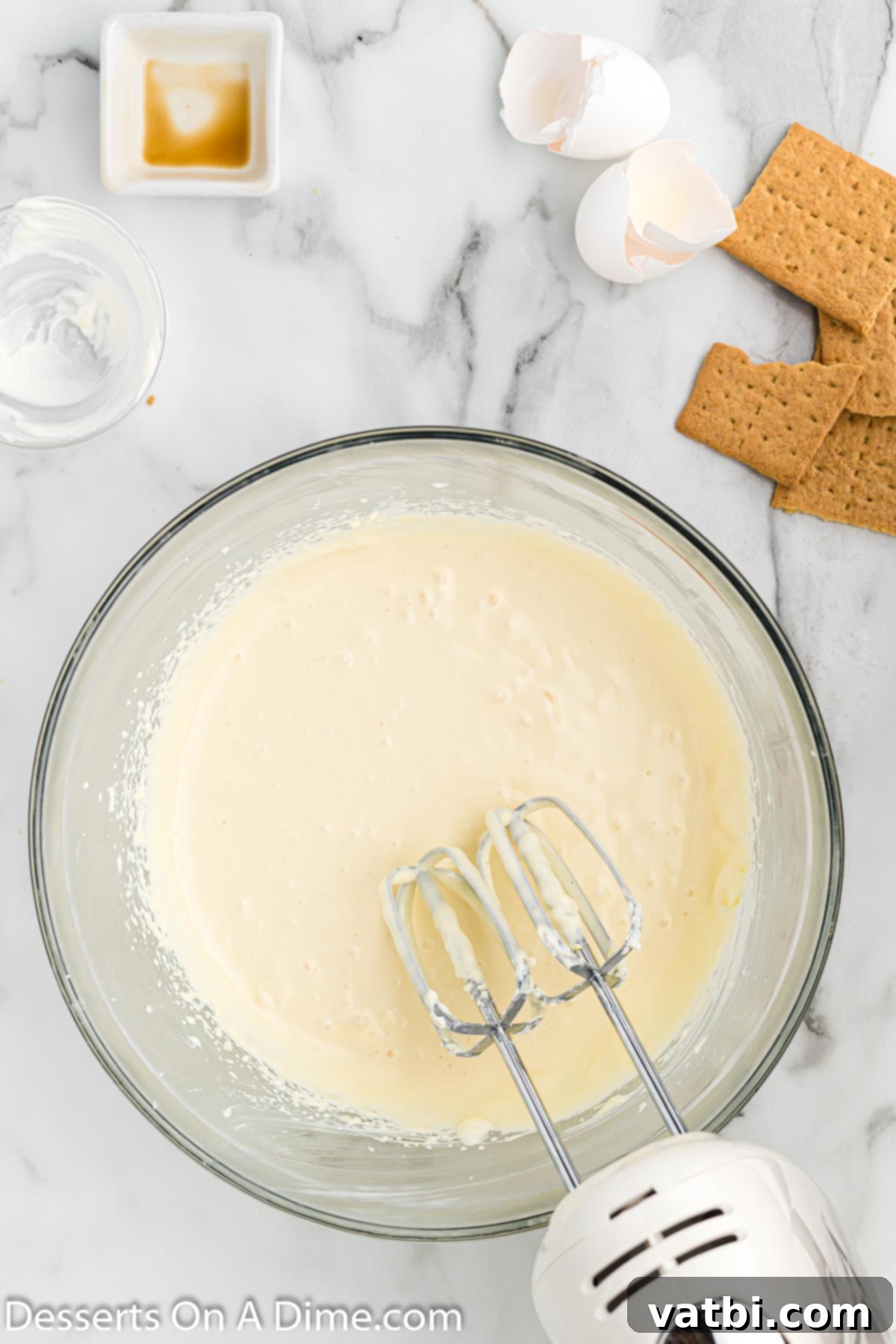 Instant Pot Cheesecake Perfection 5 Mixing the remaining cheesecake ingredients until smooth and creamy.