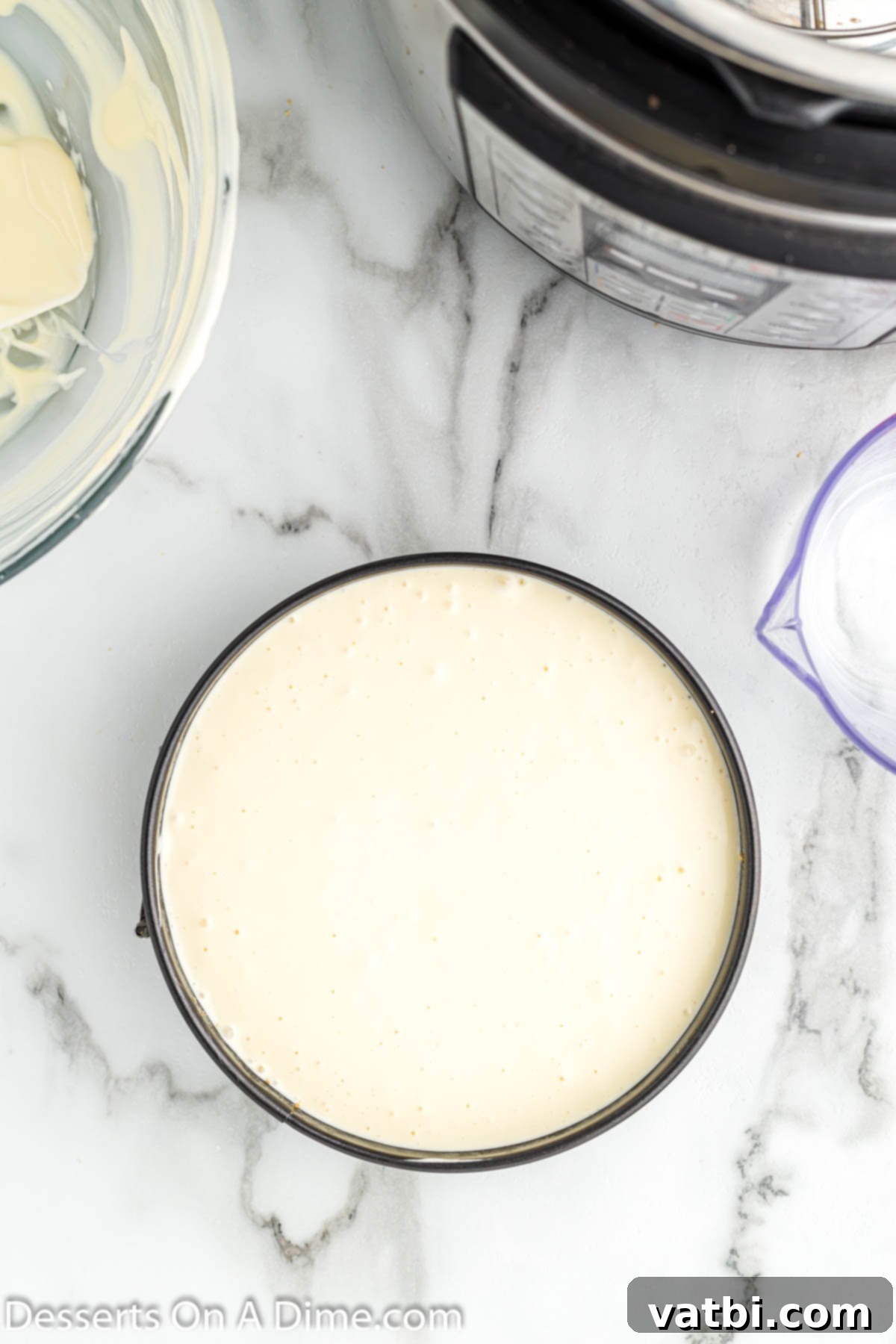 Instant Pot Cheesecake Perfection 6 Pouring the smooth cheesecake batter evenly over the chilled graham cracker crust.