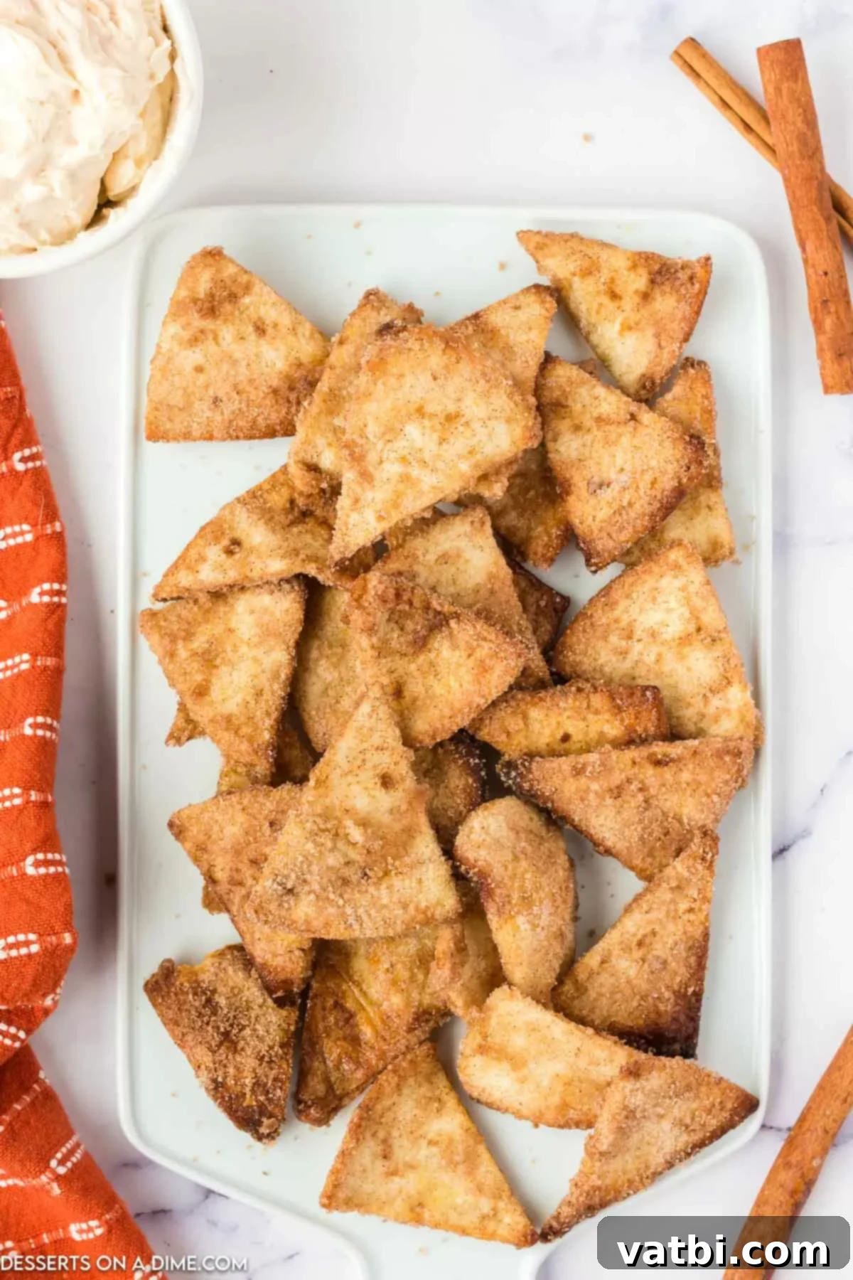 A beautifully arranged platter of golden-brown Air Fryer Churro Chips, perfectly coated in cinnamon sugar, ready to be enjoyed with a creamy dip.
