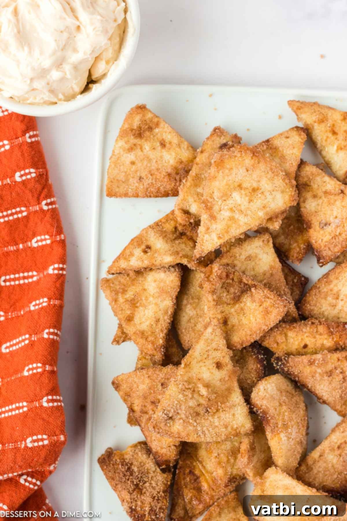 A large serving platter piled high with Air Fryer Churro Chips, garnished with a light dusting of extra cinnamon sugar.
