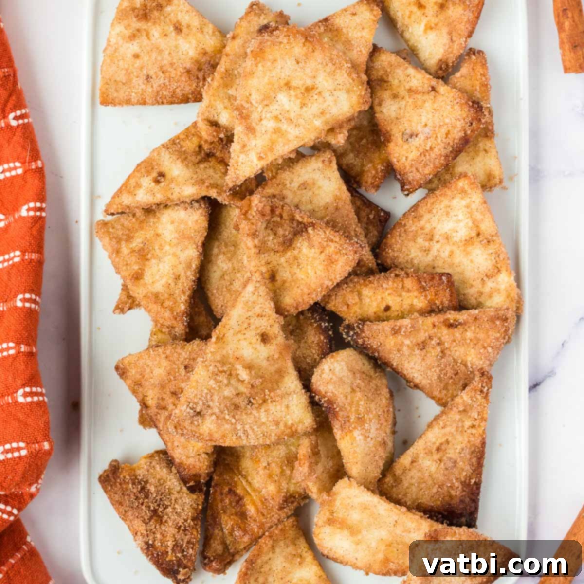 A festive platter of Air Fryer Churro Chips and a bowl of creamy caramel dip, perfect for sharing.
