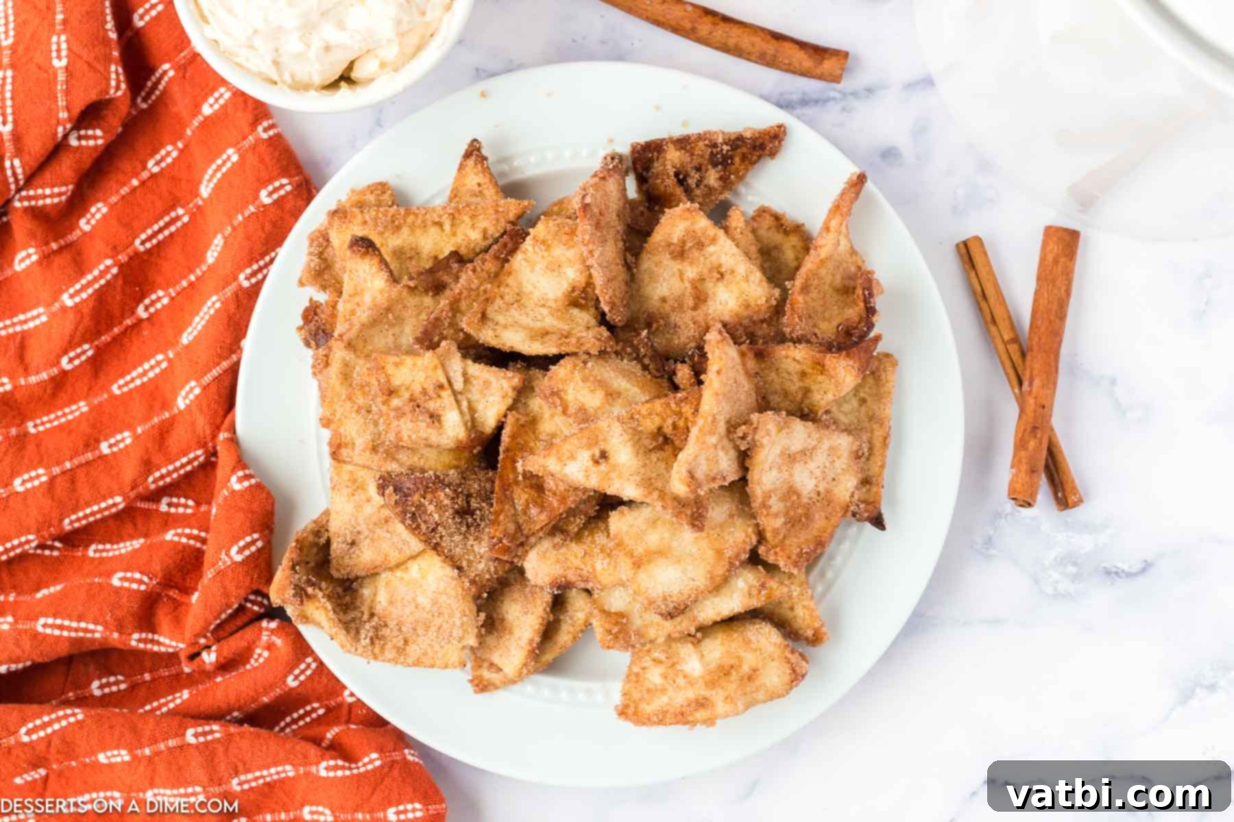 A vibrant display of Air Fryer Churro Chips artfully arranged with various dipping sauces, creating an inviting dessert spread.
