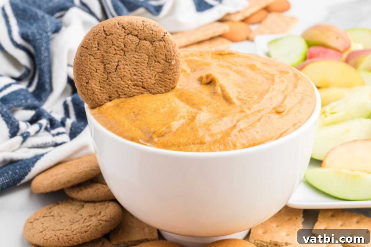 Delicious Pumpkin Dip 2 Pumpkin dip in a white bowl with cookies.