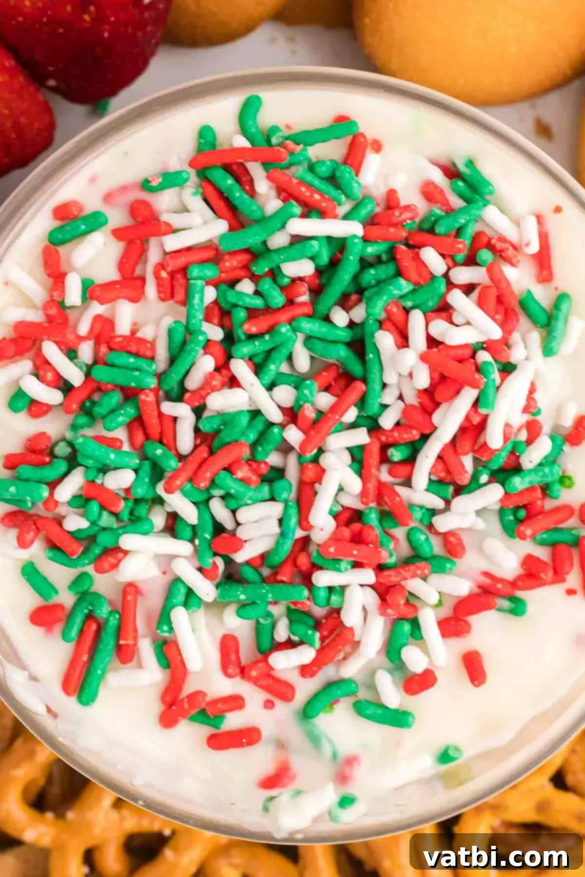 Santa's Favorite Cookie Dip 2 Christmas cookie dip with red and green sprinkles in a decorative serving dish, ready to be enjoyed.