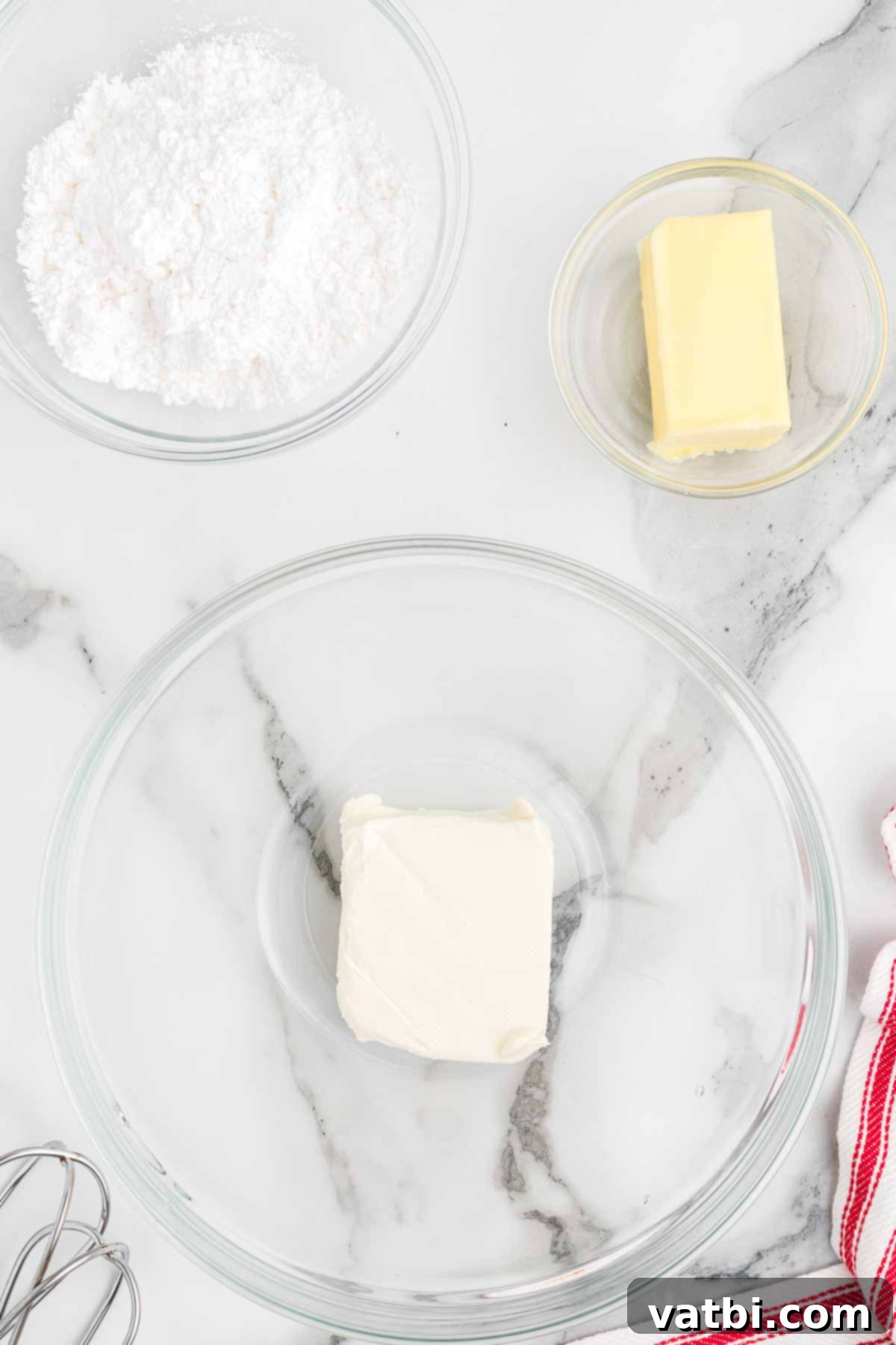 Santa's Favorite Cookie Dip 3 All the ingredients for Christmas cookie dip laid out on a table: vanilla Greek yogurt, cream cheese, butter, vanilla extract, confectioners sugar, flour, and holiday sprinkles.