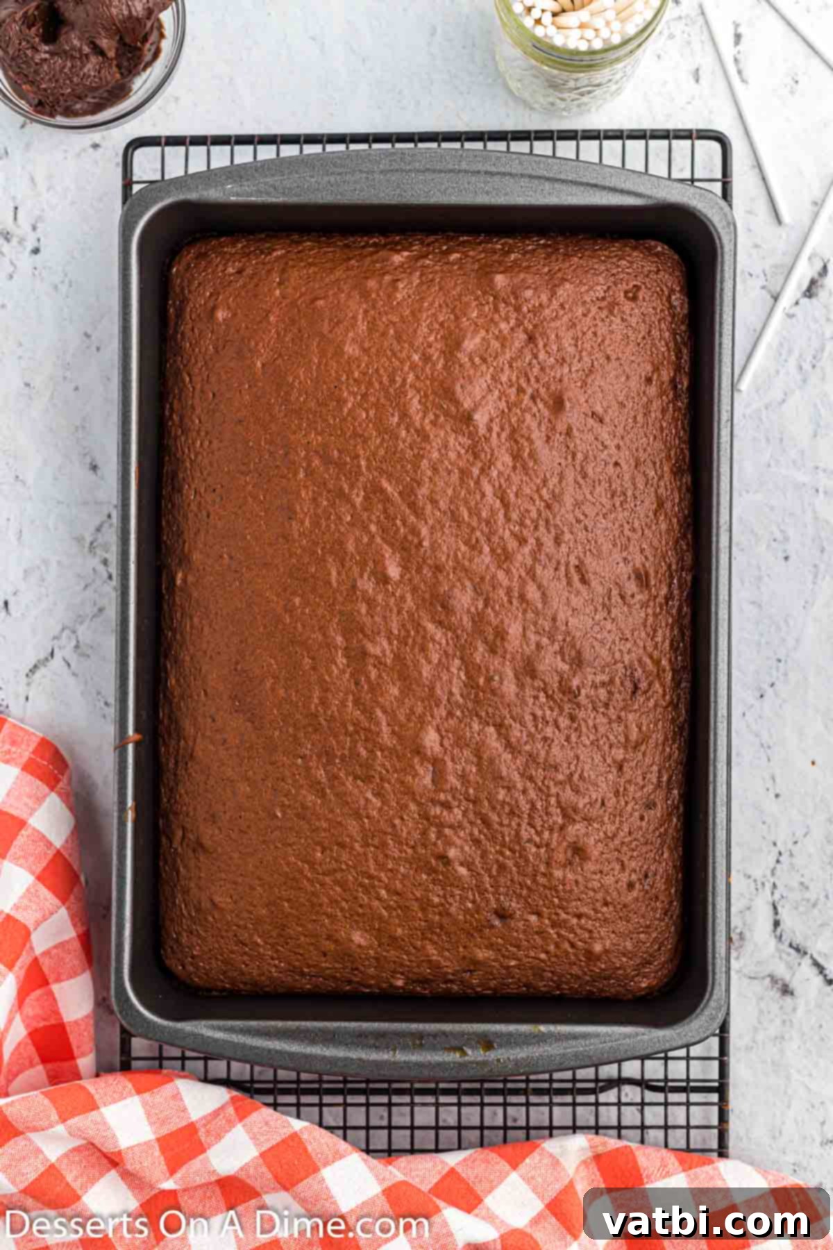 Freshly baked chocolate cake cooling in a 9x13 inch baking pan, ready for making cake pops.