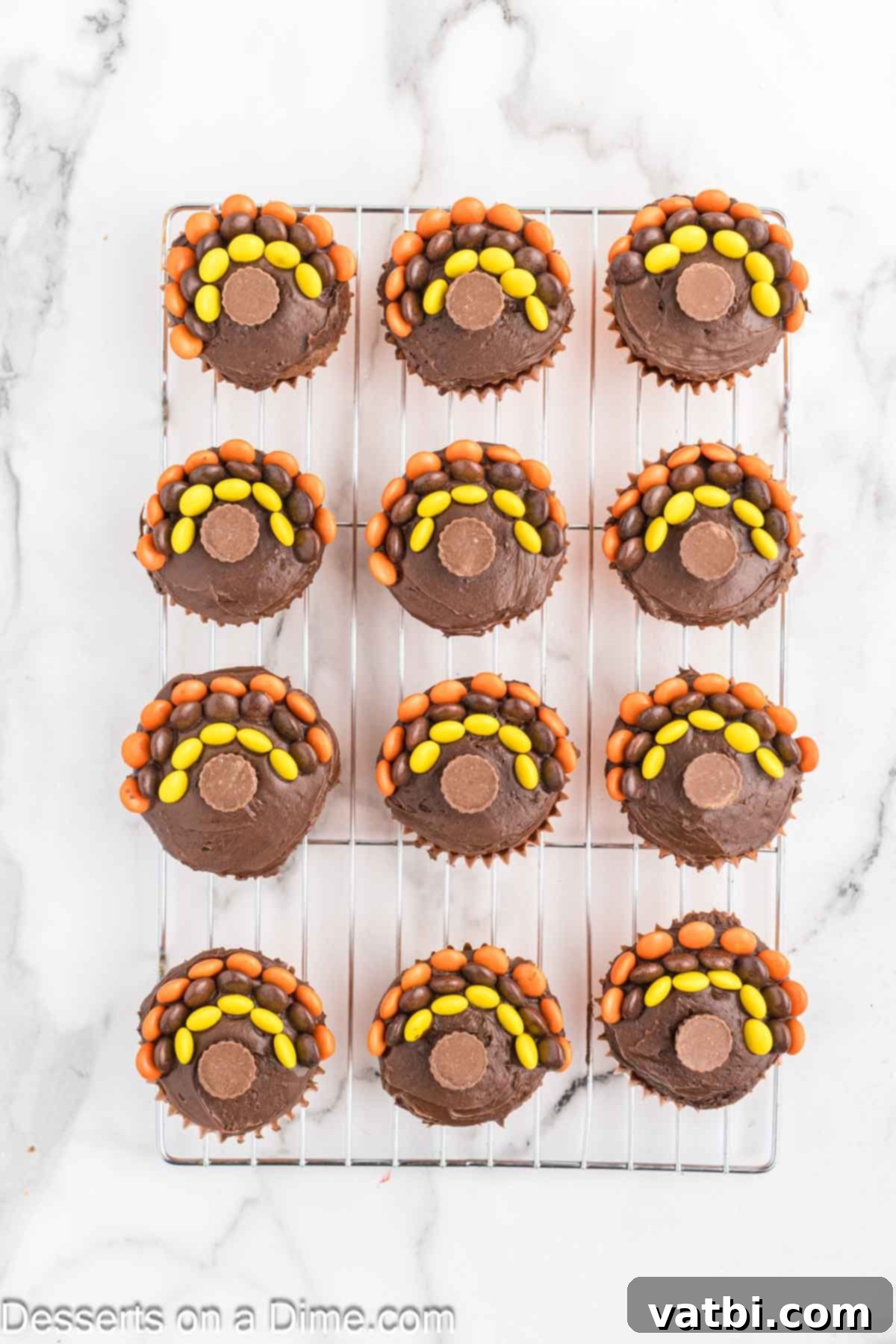 Cupcake topped with peanut butter cup. 
