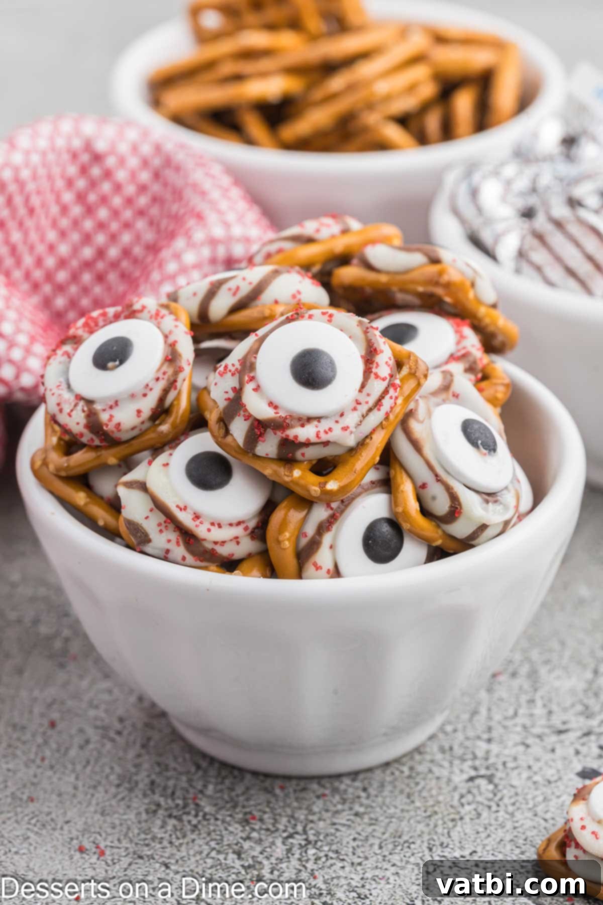 A close-up of a perfectly crafted Halloween Pretzel Monster Eyeball on a serving platter, showcasing its spooky details.