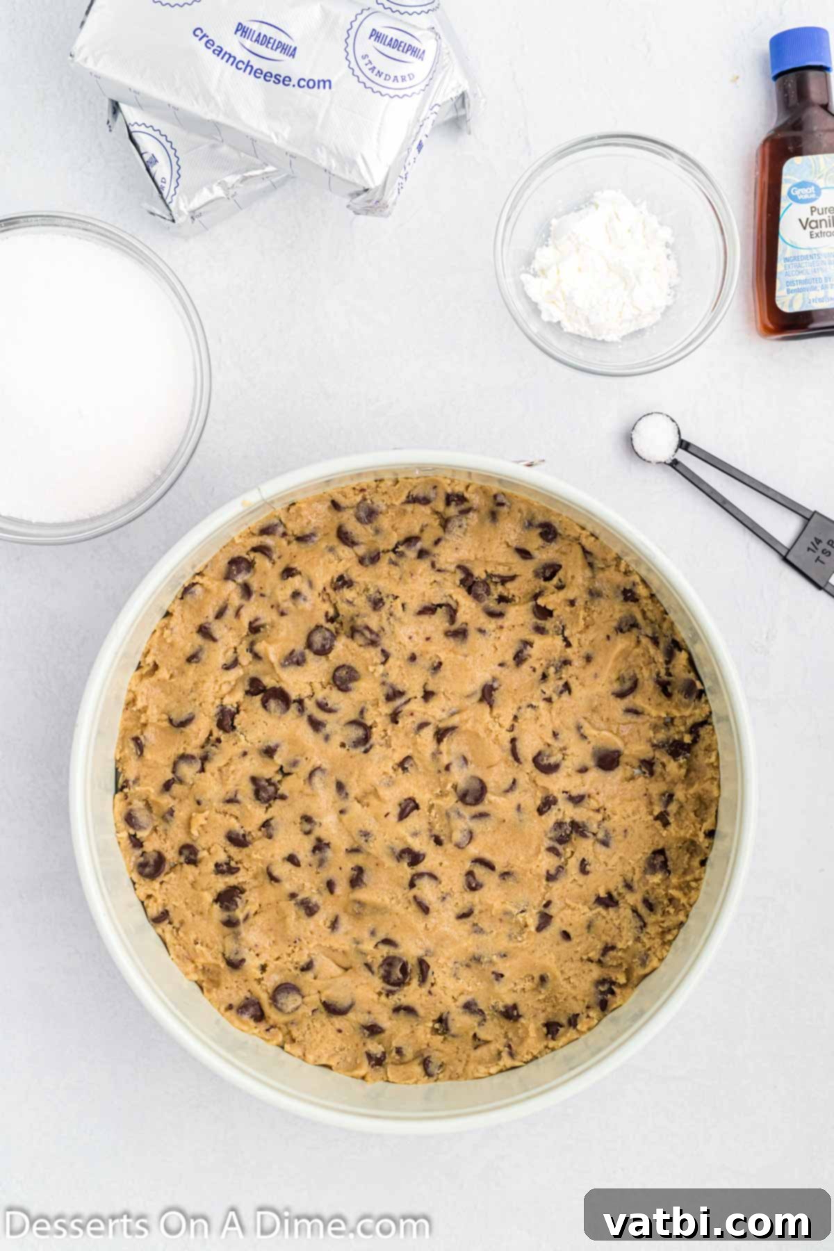 Chocolate Chip Cookie Cheesecake 4 Chocolate chip cookie dough pressed into the bottom of a springform pan, ready for the filling.