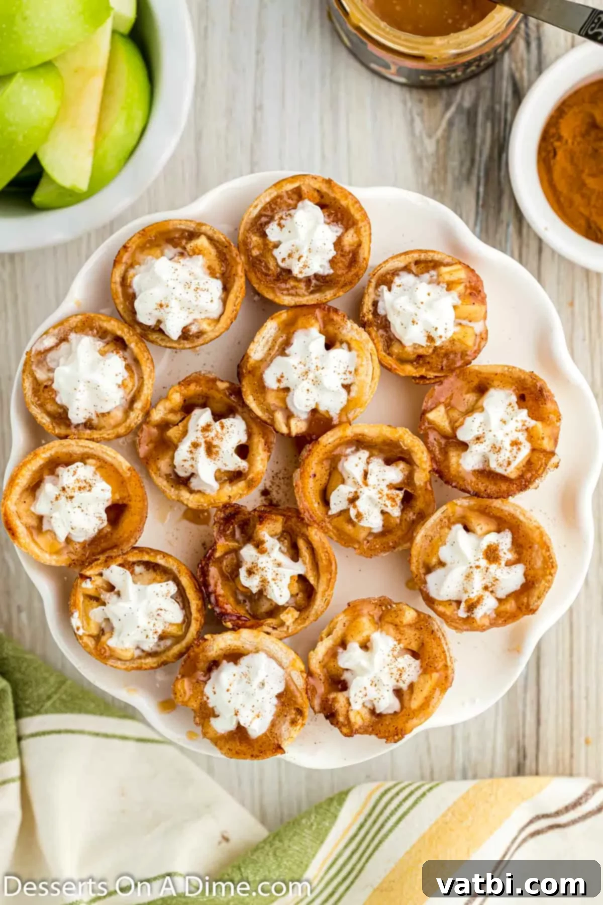 Apple Pie Poppers 13 Mini apple pie bites freshly baked and arranged on a white serving platter, ready for topping.