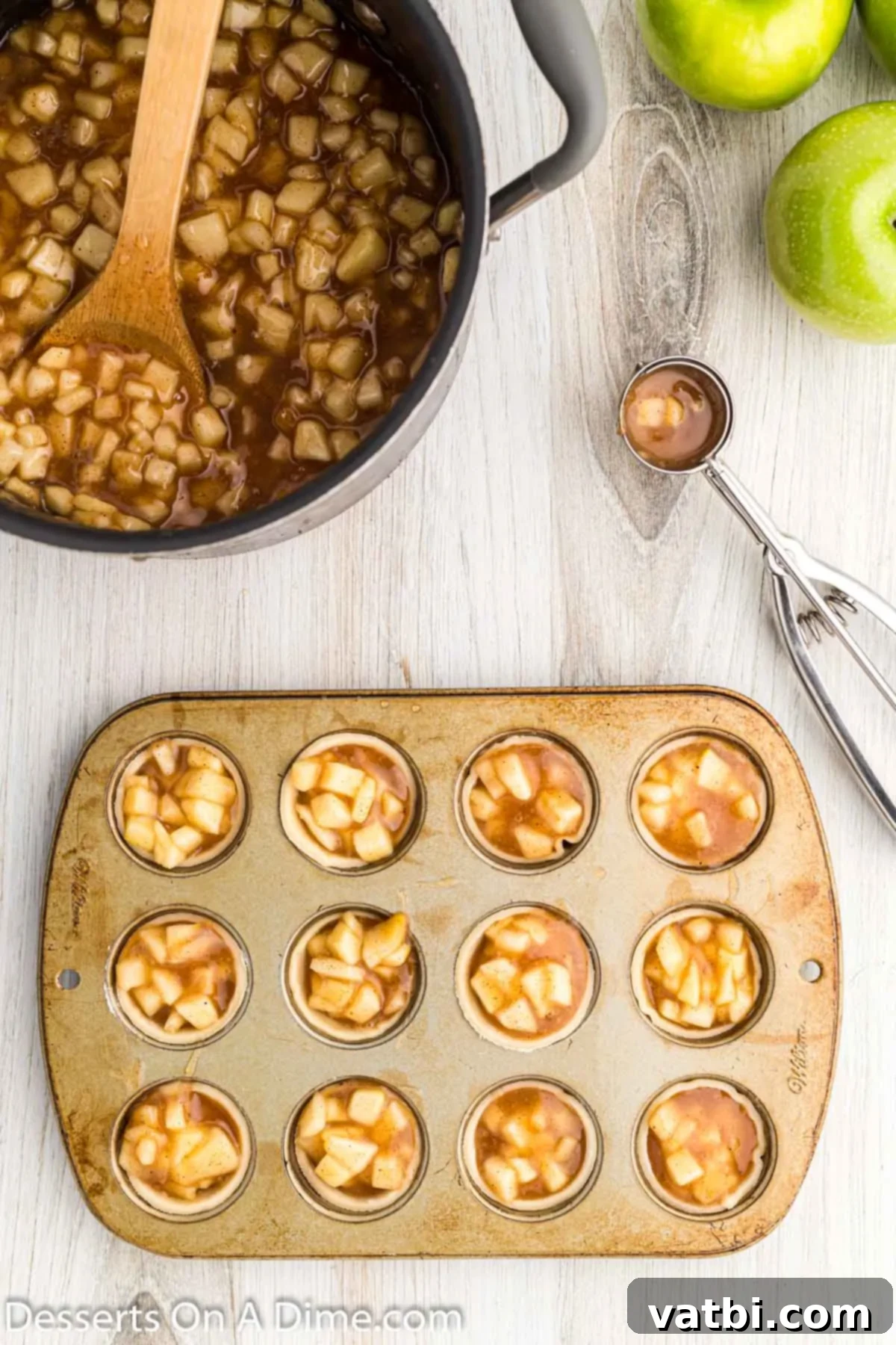 Apple Pie Poppers 10 Mini muffin tins filled with apple pie filling in each dough cup.