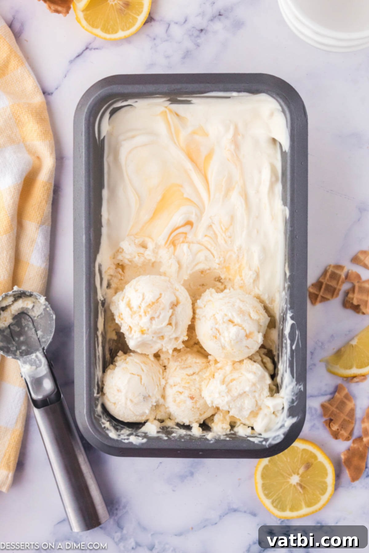 Sunshine Shortbread Ice Cream 2 Container of vibrant yellow Lemon Shortbread Ice Cream with visible cookie crumbles and lemon swirls.