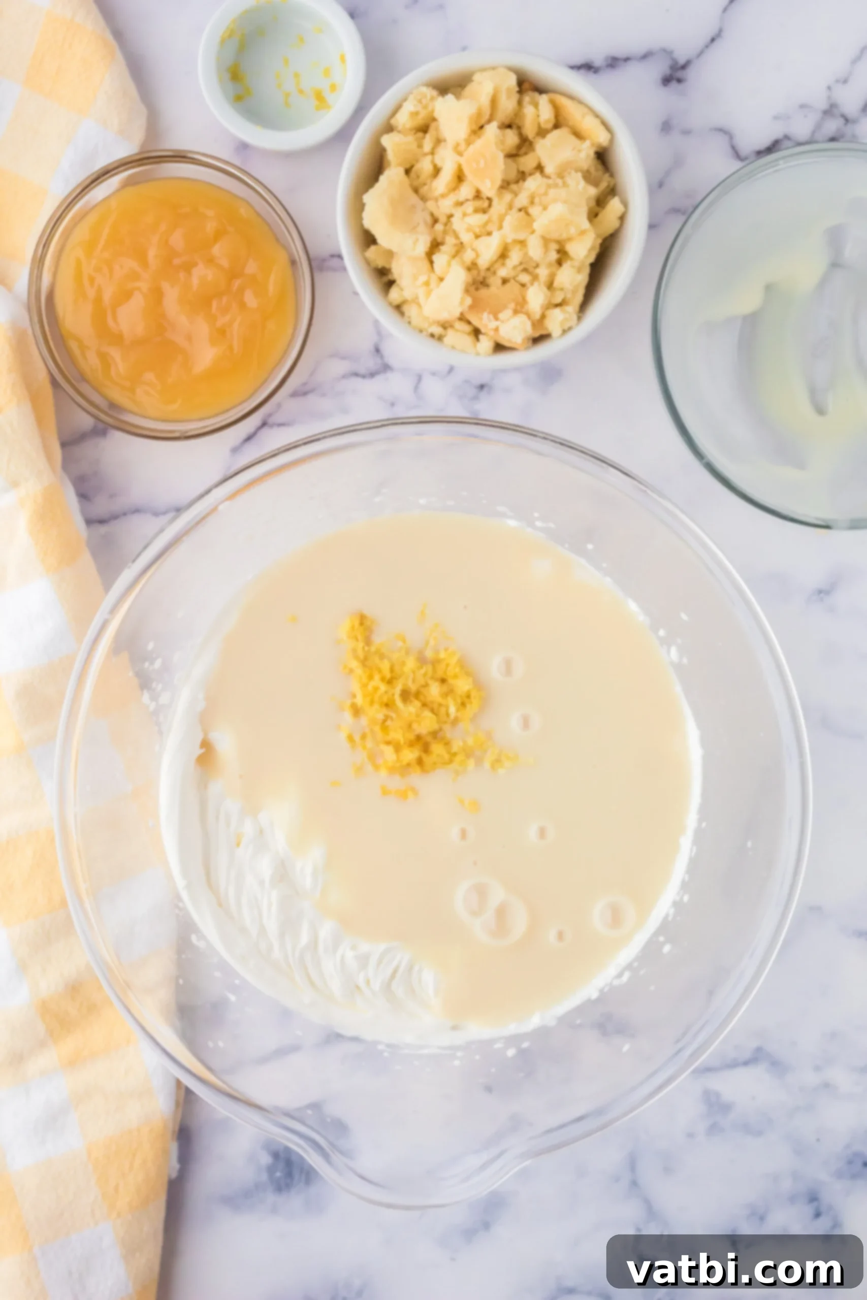 Sunshine Shortbread Ice Cream 4 Mixing bowl with sweetened condensed milk and lemon zest being folded into whipped cream.