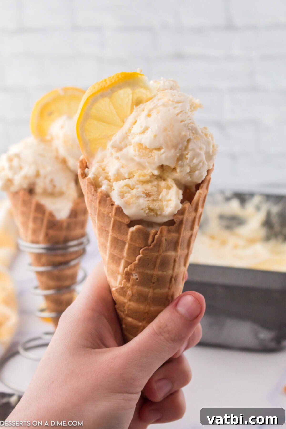 Sunshine Shortbread Ice Cream 7 A scoop of Lemon Shortbread Ice Cream in a waffle cone.