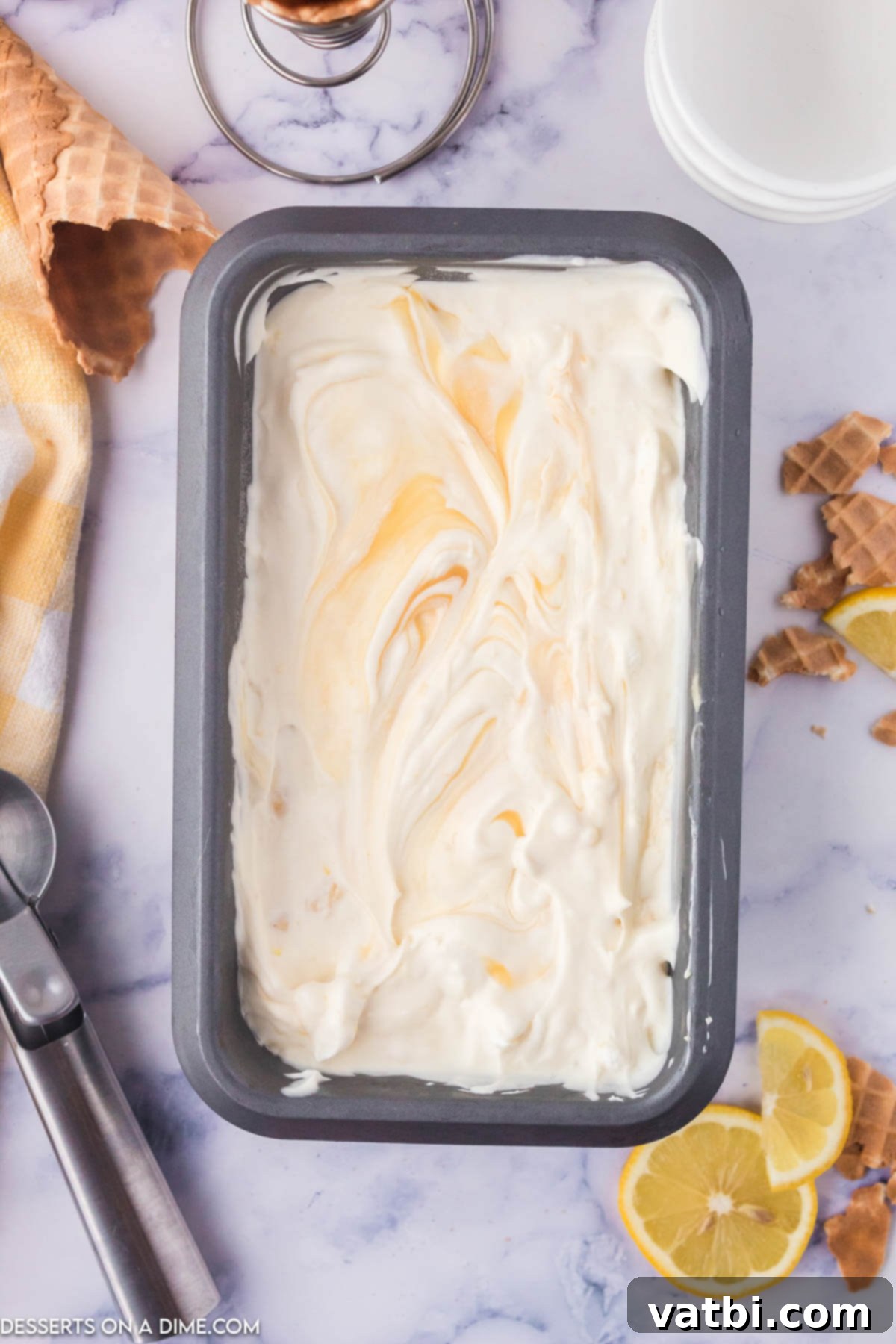 Sunshine Shortbread Ice Cream 8 A container of creamy Lemon Shortbread Ice Cream, ready to be scooped and enjoyed.