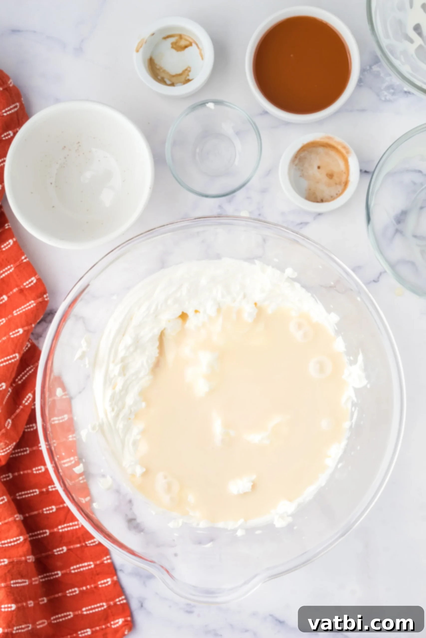 Large bowl with cold heavy cream and sweetened condensed milk.
