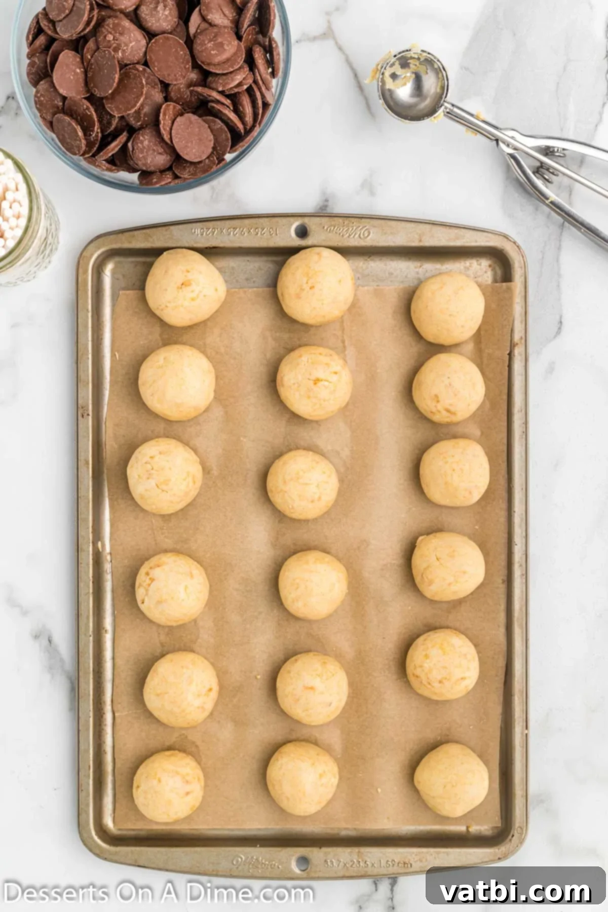 Festive Reindeer Cake Pops 6 Cake balls on baking sheet. Uniformly shaped cake balls placed on a baking sheet, ready for chilling.